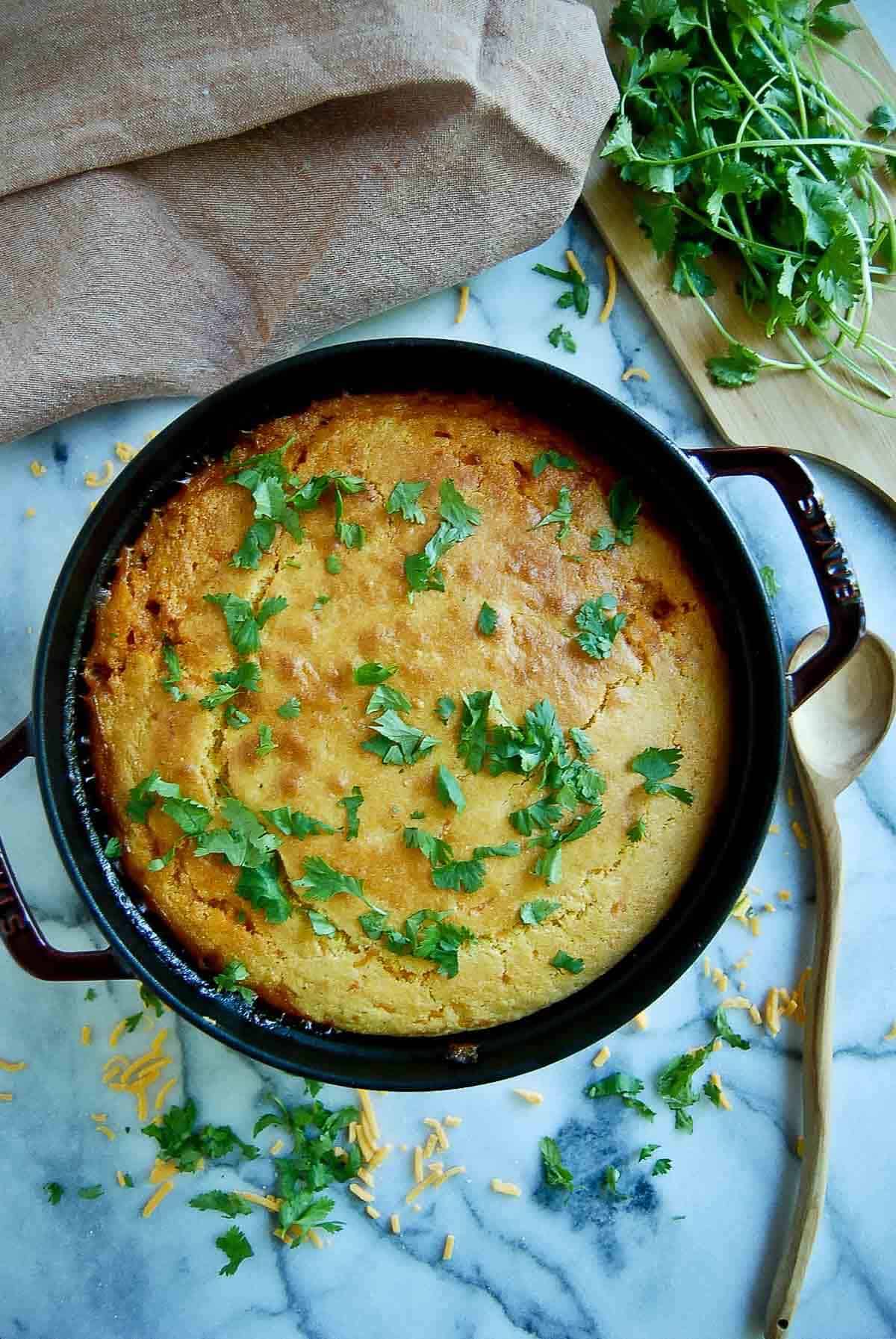 cornbread cowboy casserole in dutch oven on countertop.