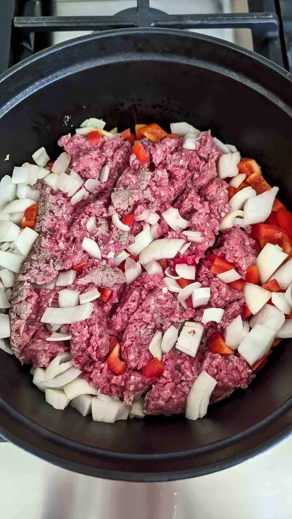 ground beef, onions and red pepper cooking in pot.