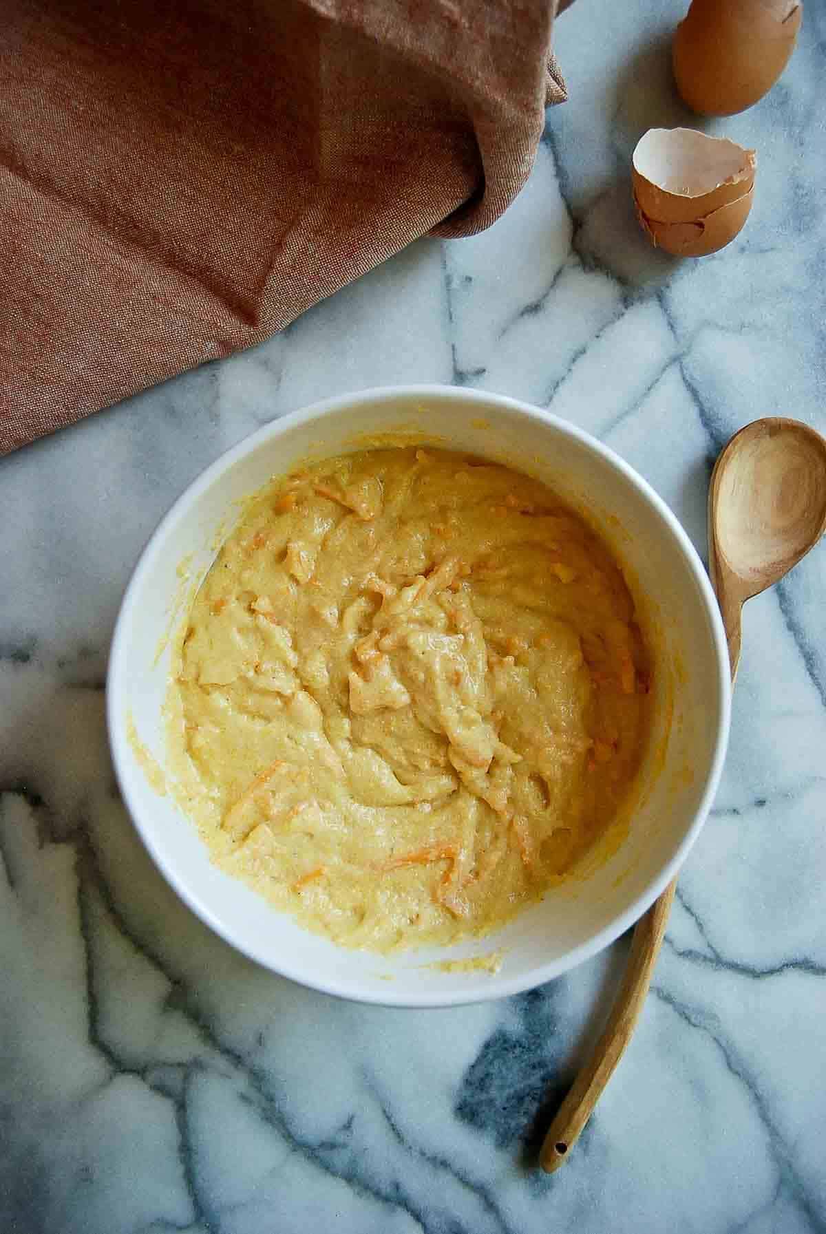 Cornbread mixture with shredded cheese mixed in.