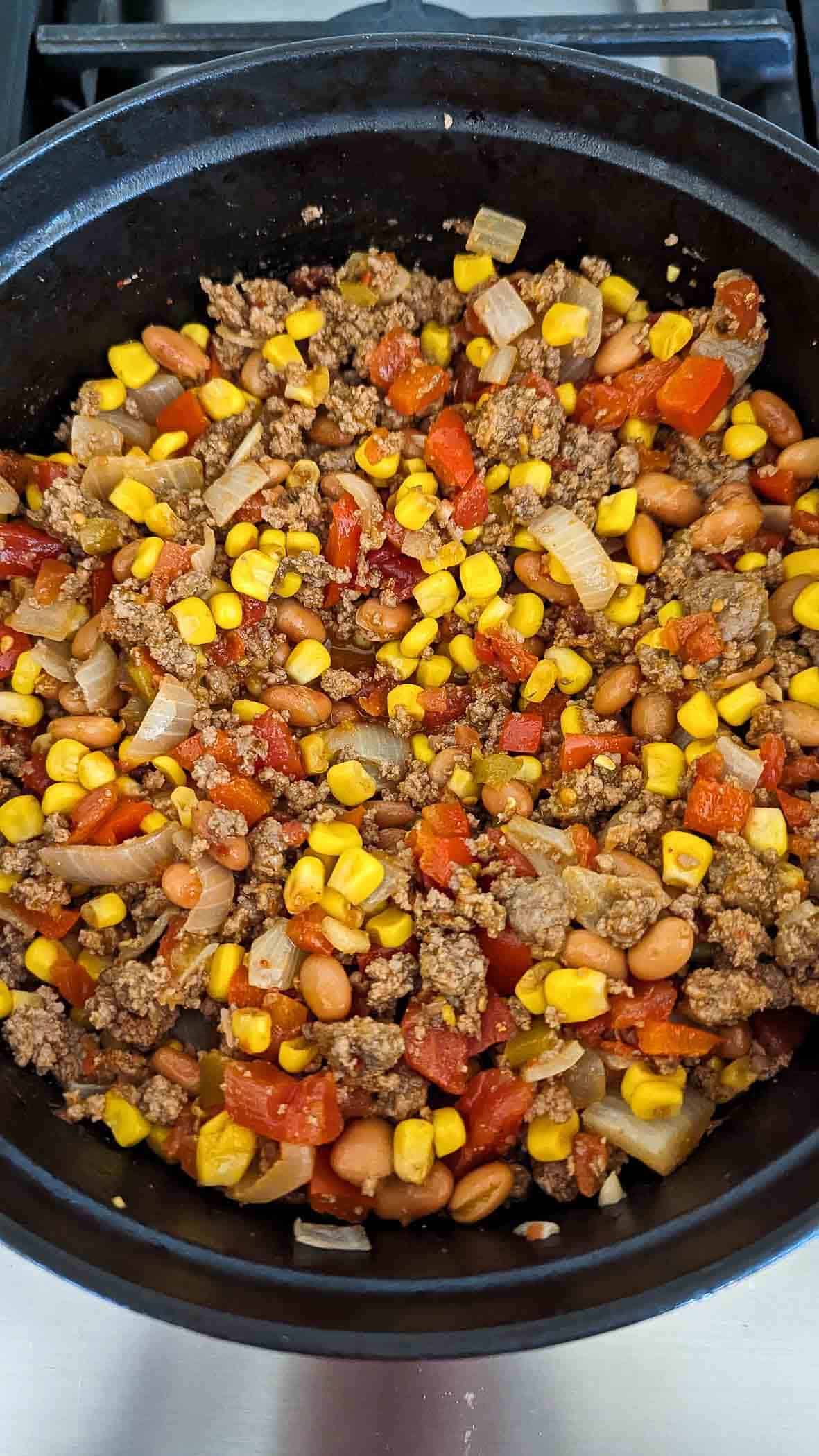 cooked ground beef mixture with rotel, corn, and spices added.