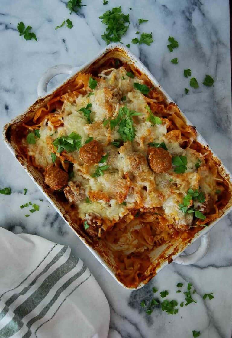 dump and bake meatball casserole on countertop with one serving removed.