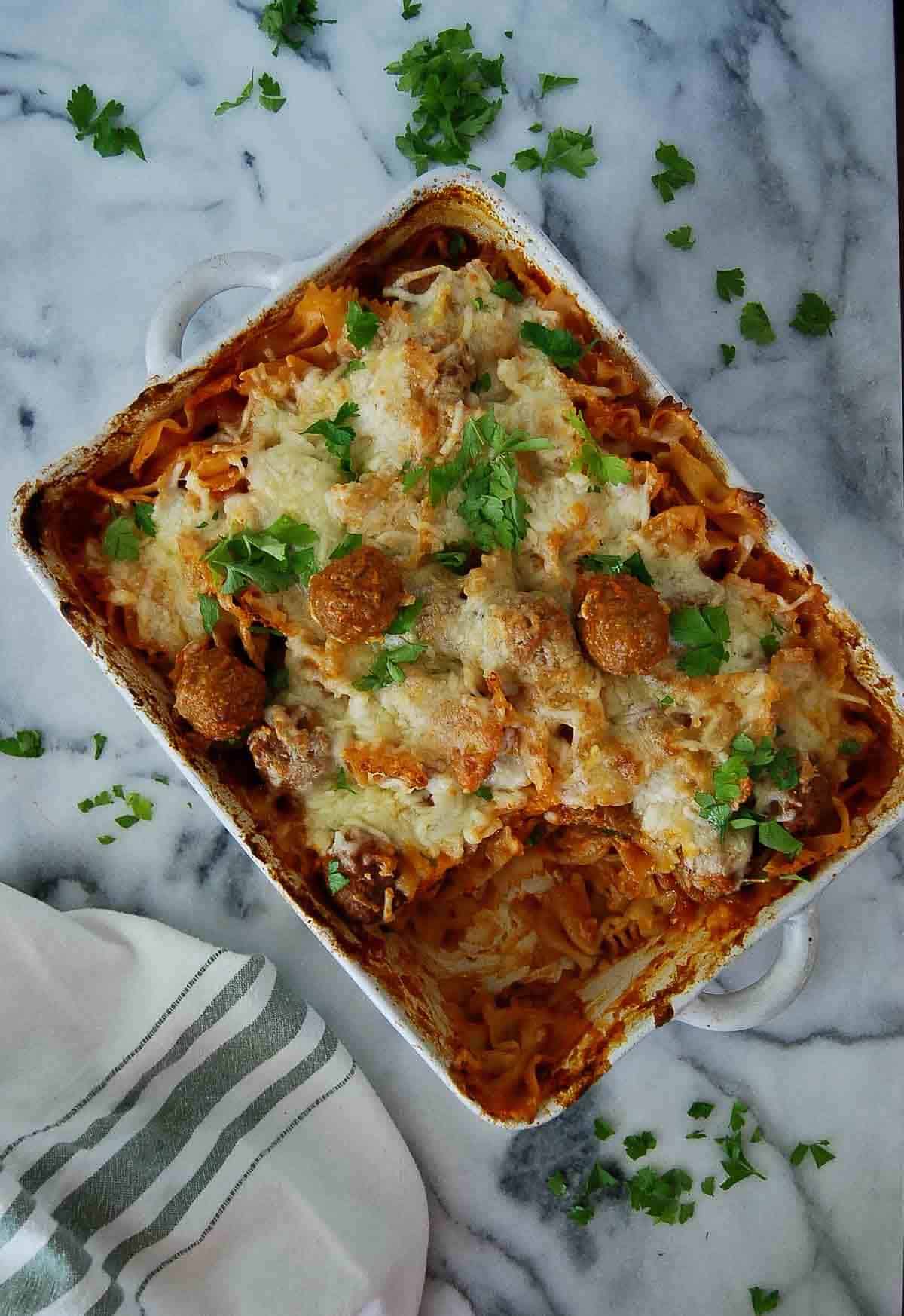 dump and bake meatball casserole on countertop with one serving removed.