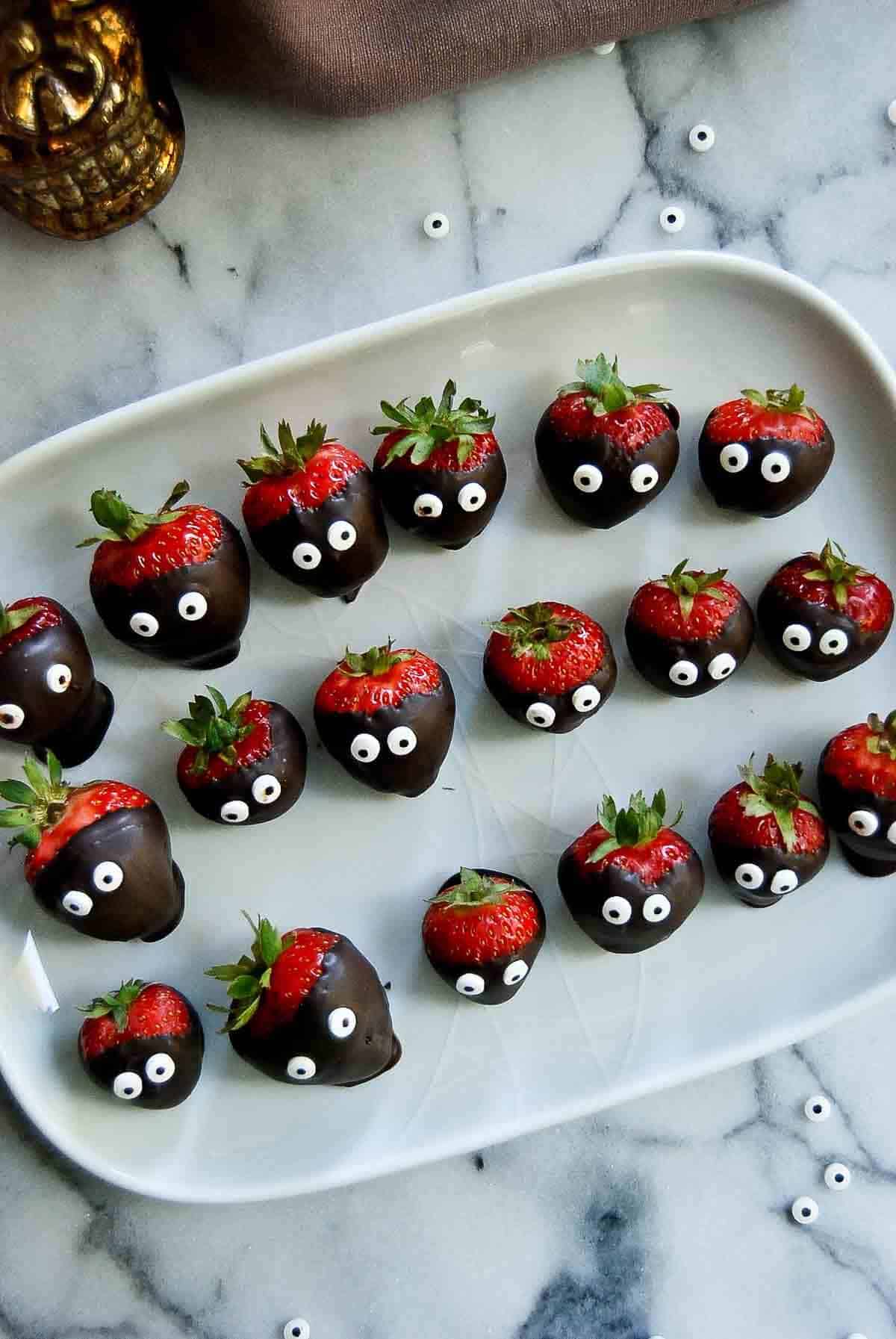 halloween chocolate covered strawberries on serving tray