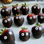 halloween chocolate covered strawberries on serving tray.