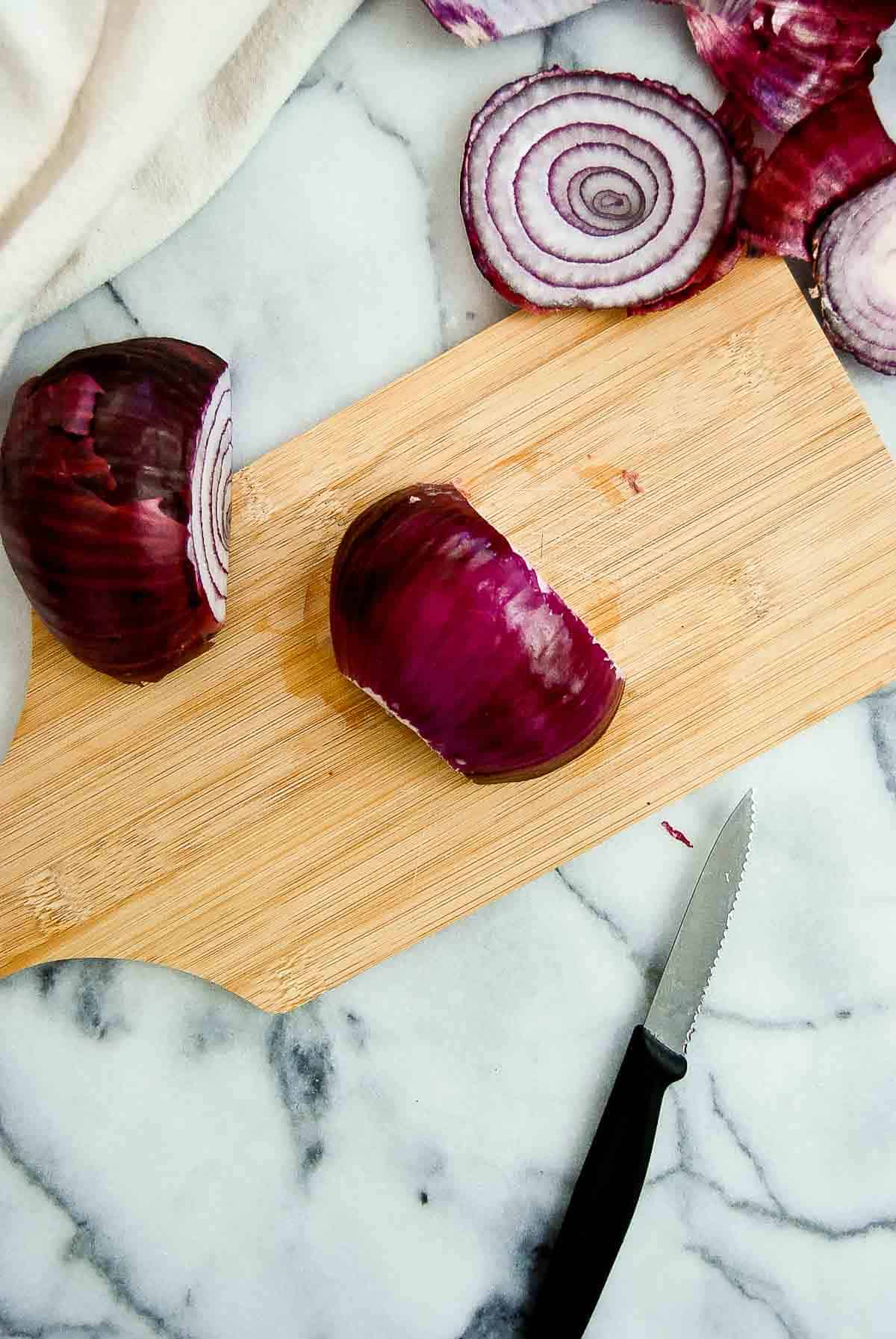 onion, cut in half on cutting board.