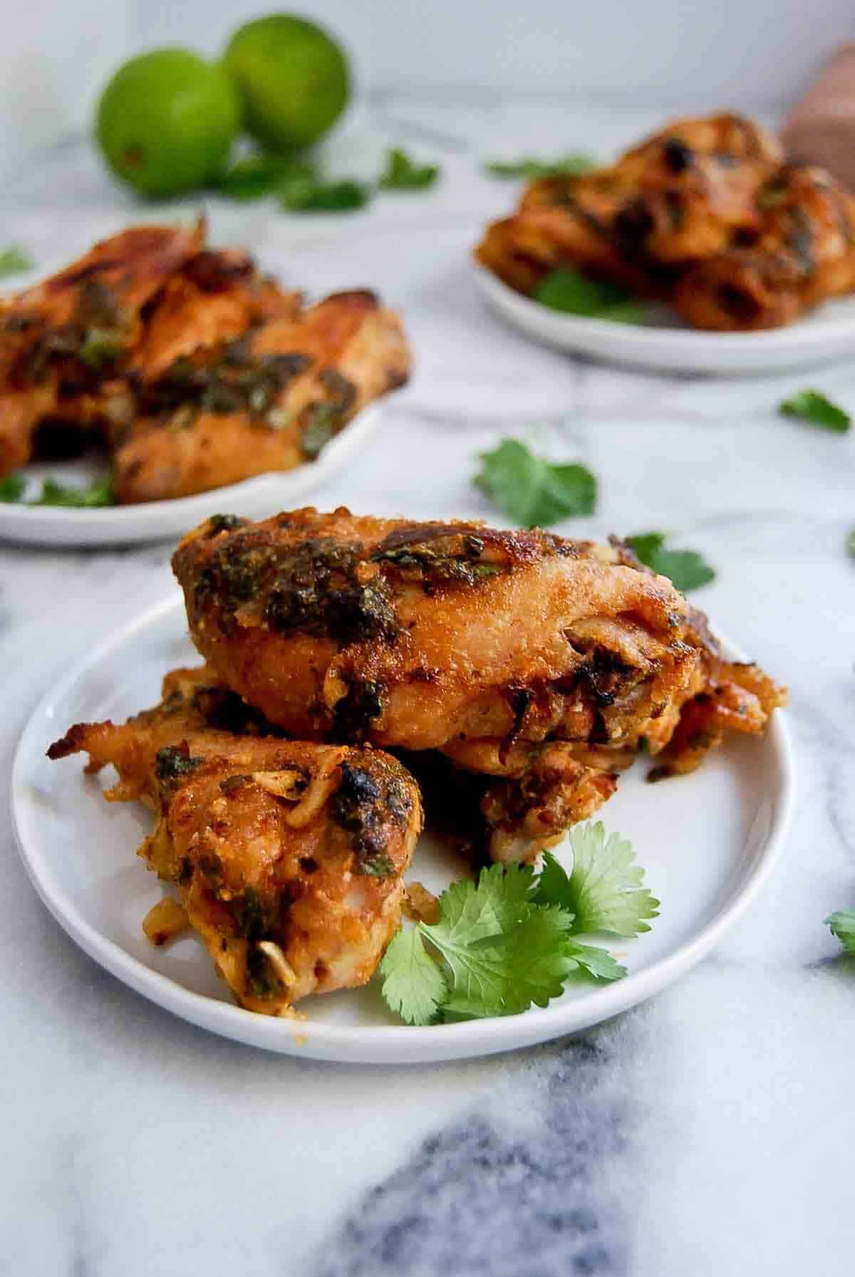 tequila lime chicken wings on plate with fresh cilantro.