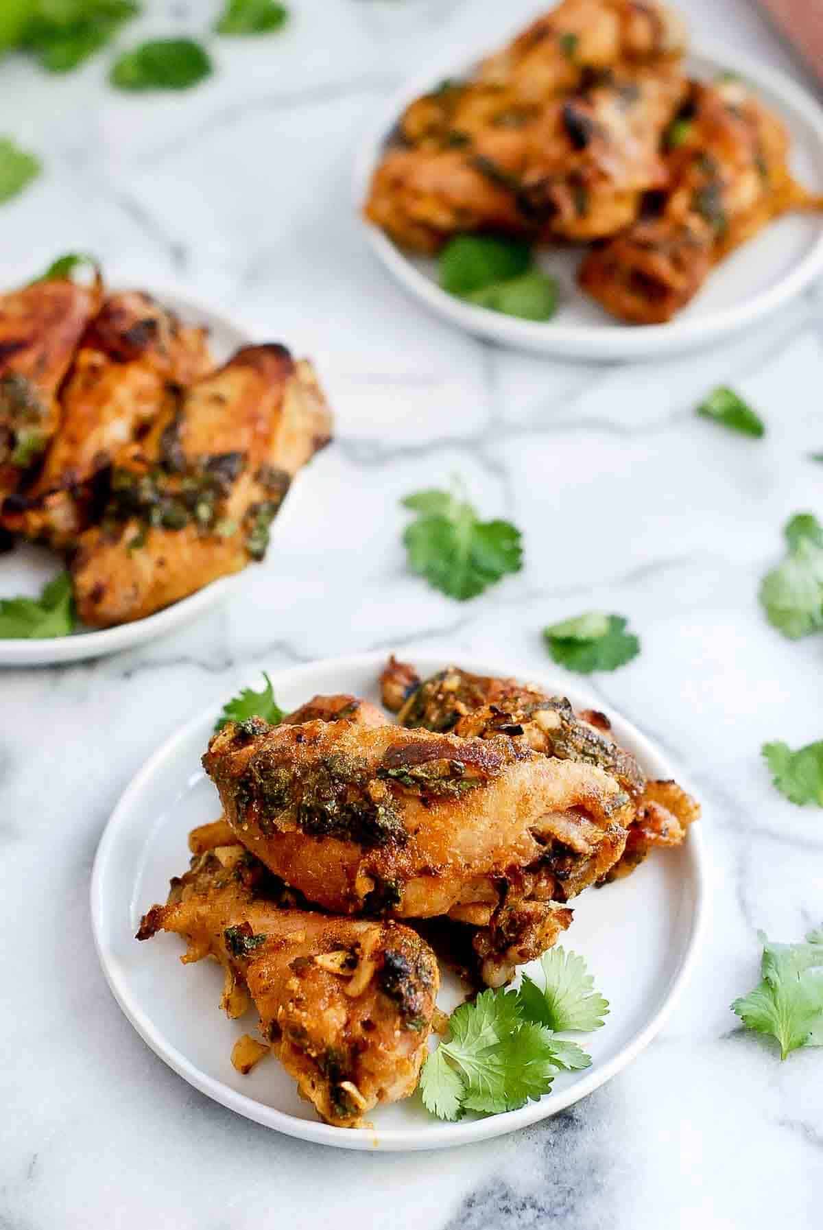 tequila lime chicken wings on plate with fresh cilantro.