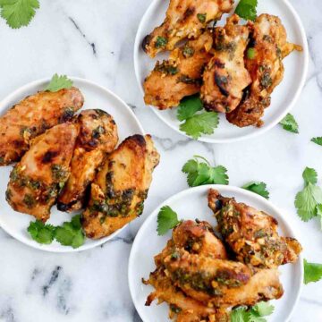 closeup of tequila lime chicken wings on plates.