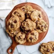 chewy chocolate chip walnut cookies on cutting board.