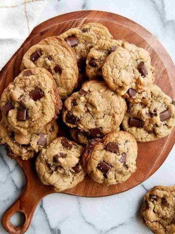 chewy chocolate chip walnut cookies on cutting board.