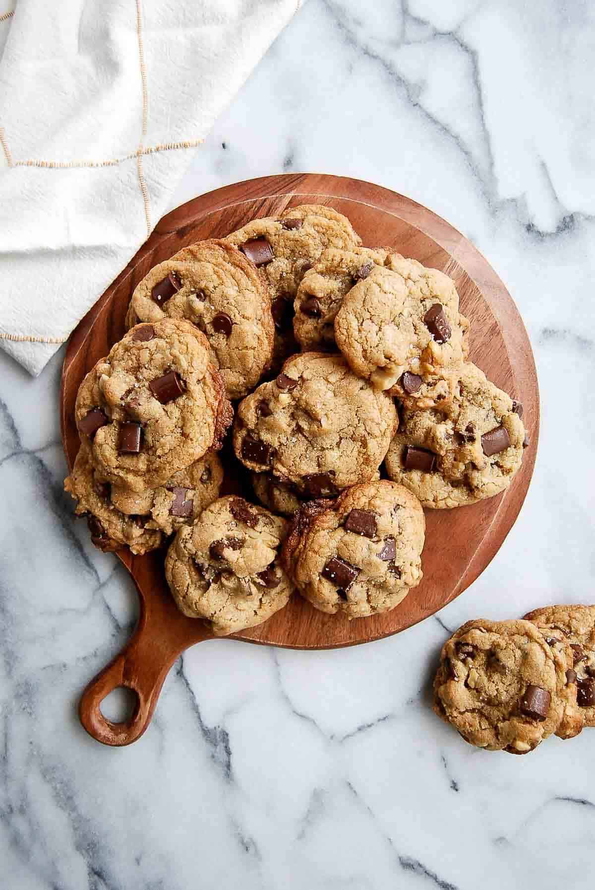 chocolate chip walnut cookies on cutting board.