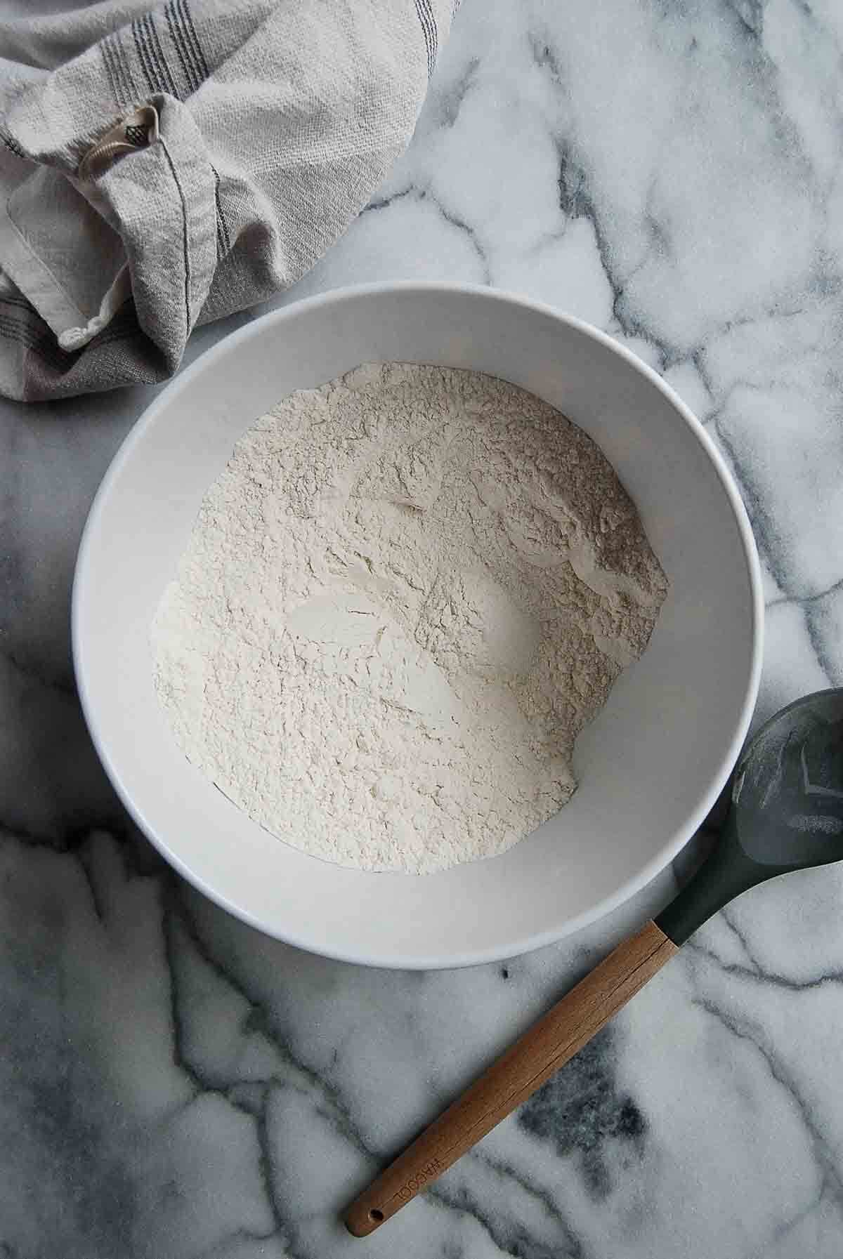 bowl of all purpose flour on countertop.