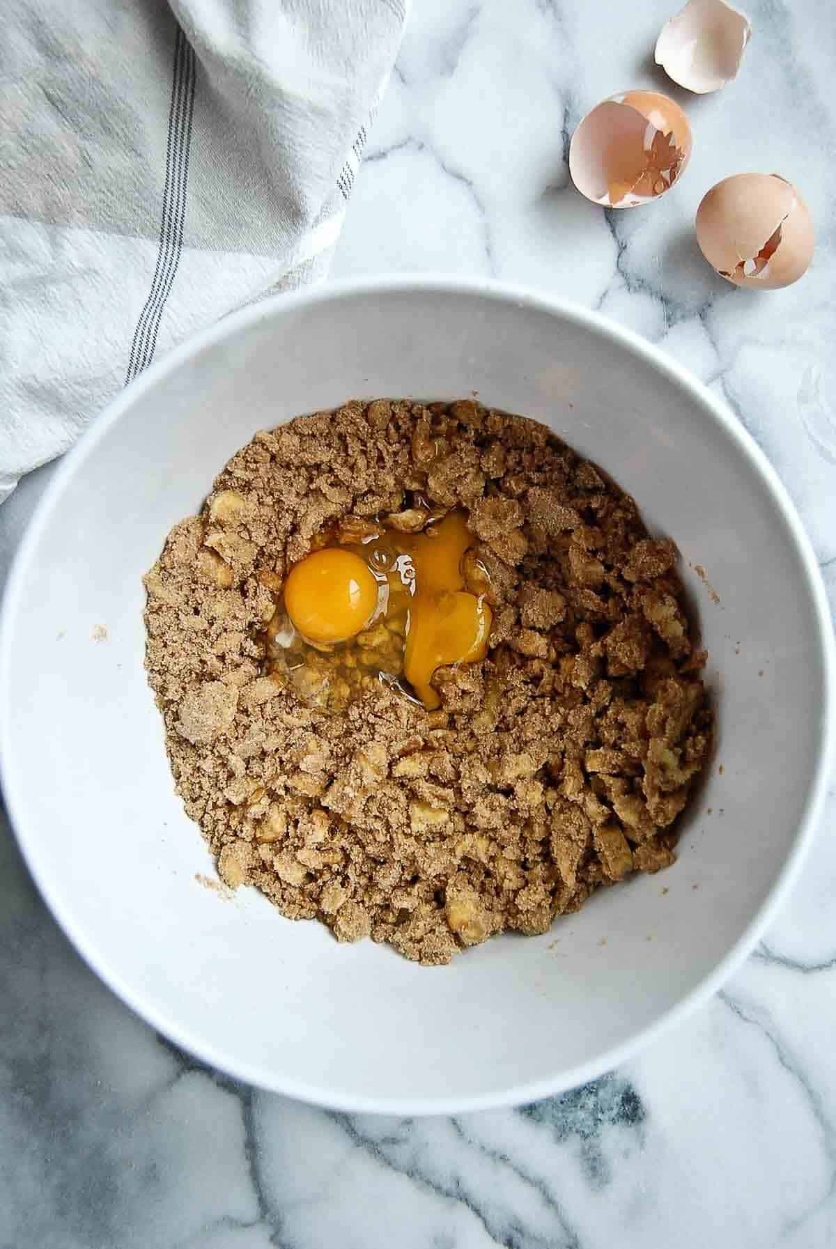 butter and sugar with eggs and vanilla added to bowl.