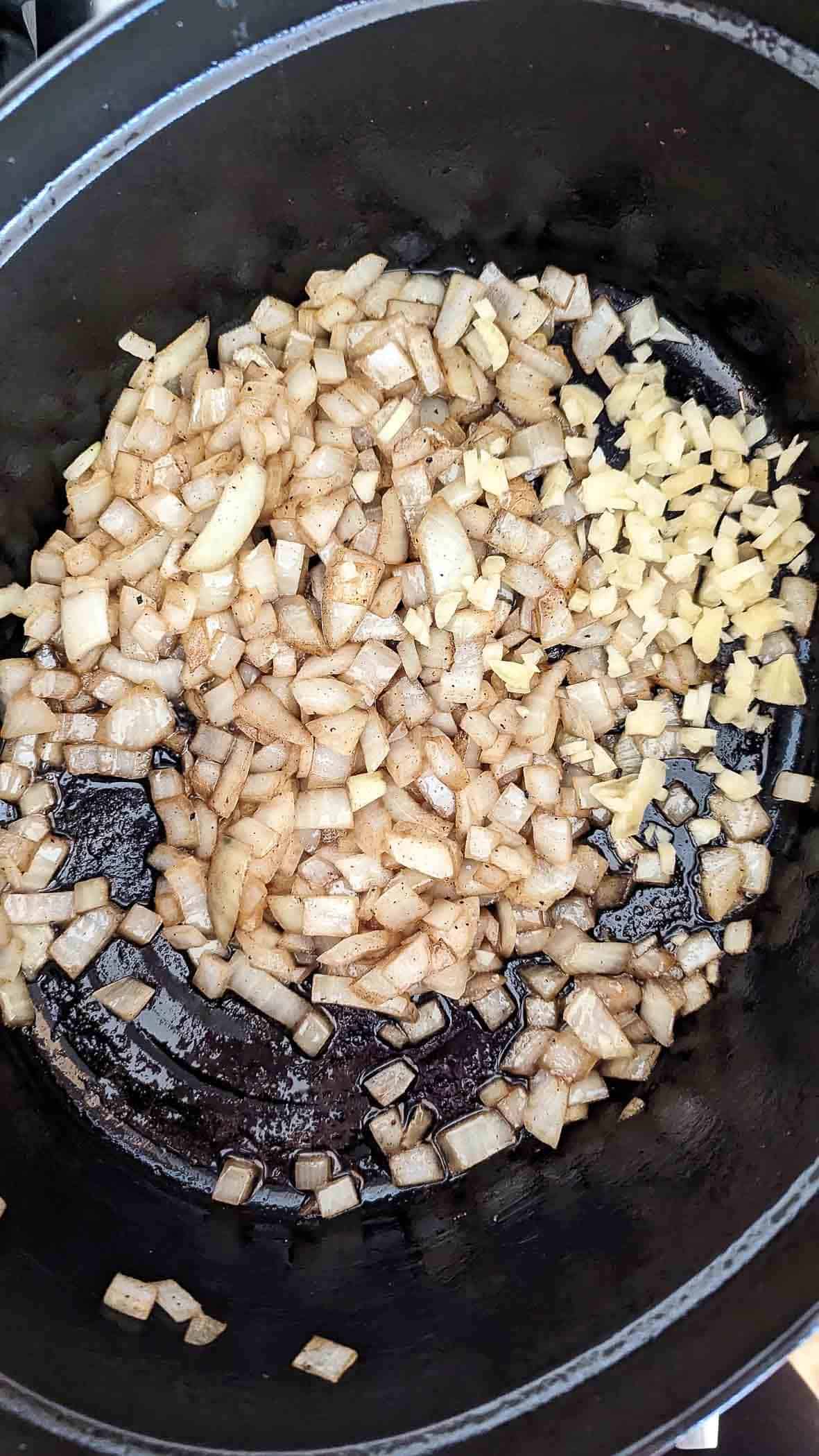 onion and garlic sautéing in dutch oven.