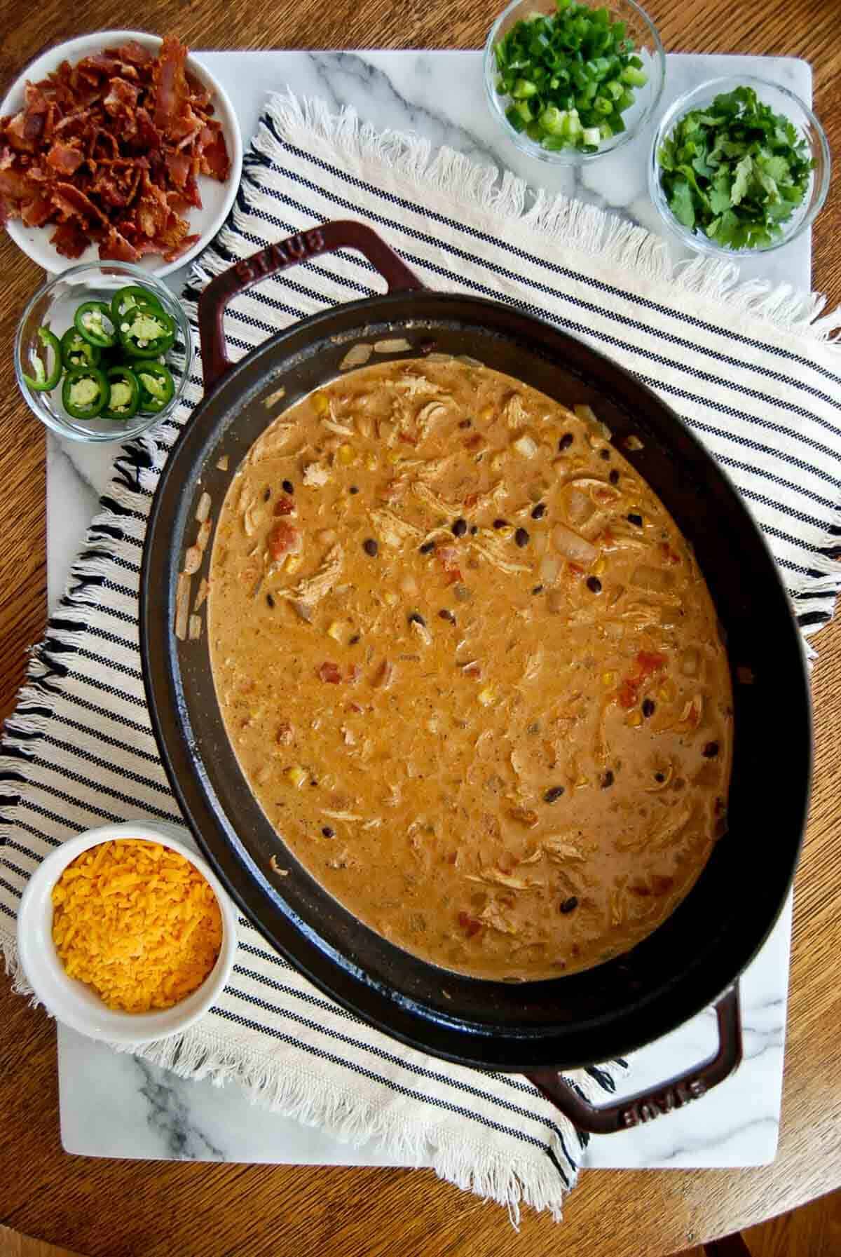 crack chicken chili in dutch oven on cutting board.