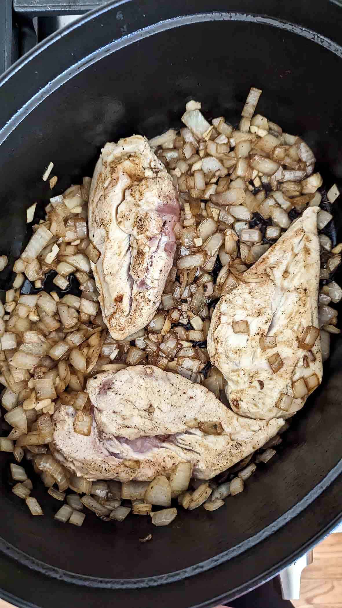 chicken breast browning in dutch oven.