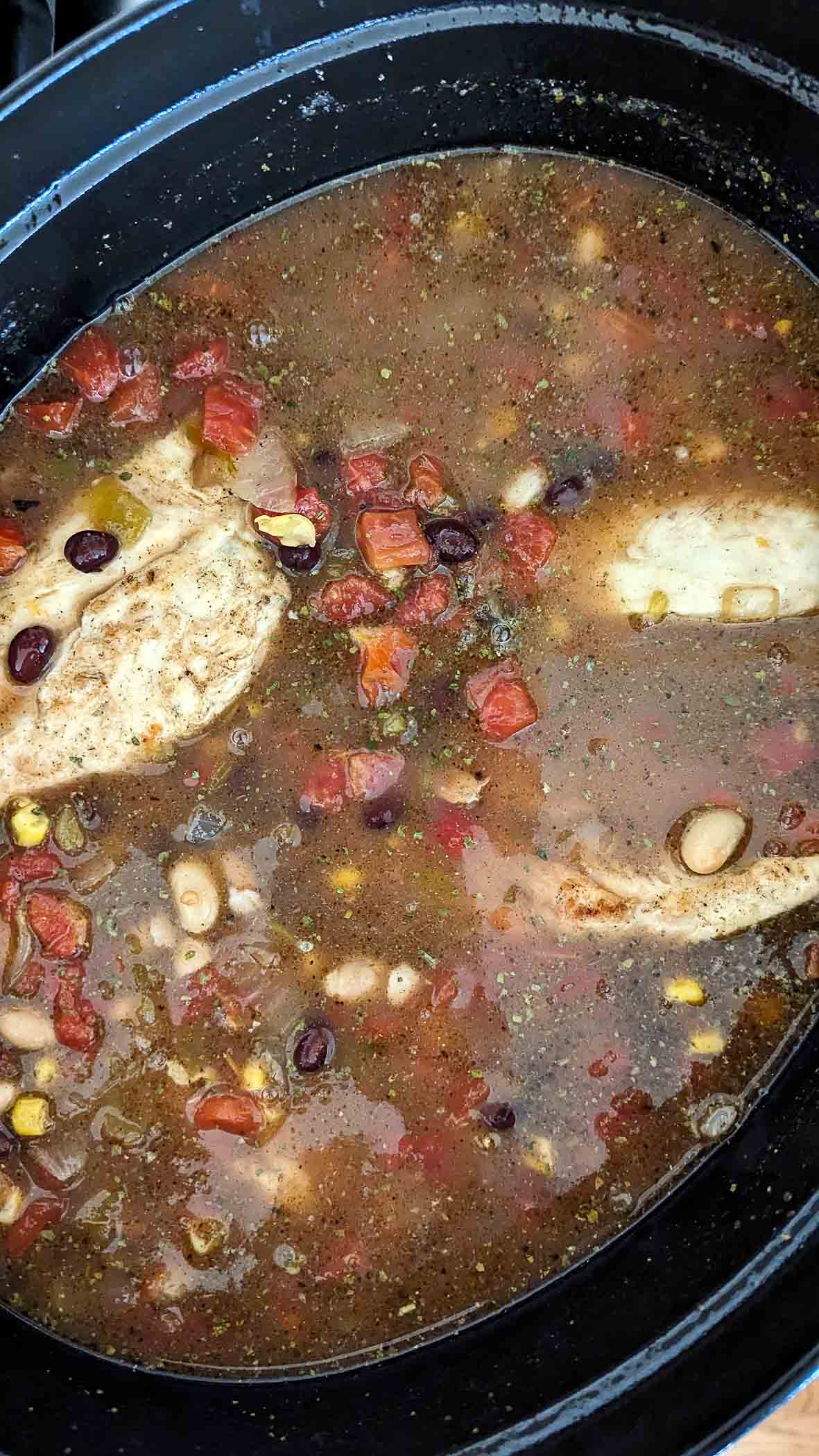 crack chicken chili simmering in dutch oven.