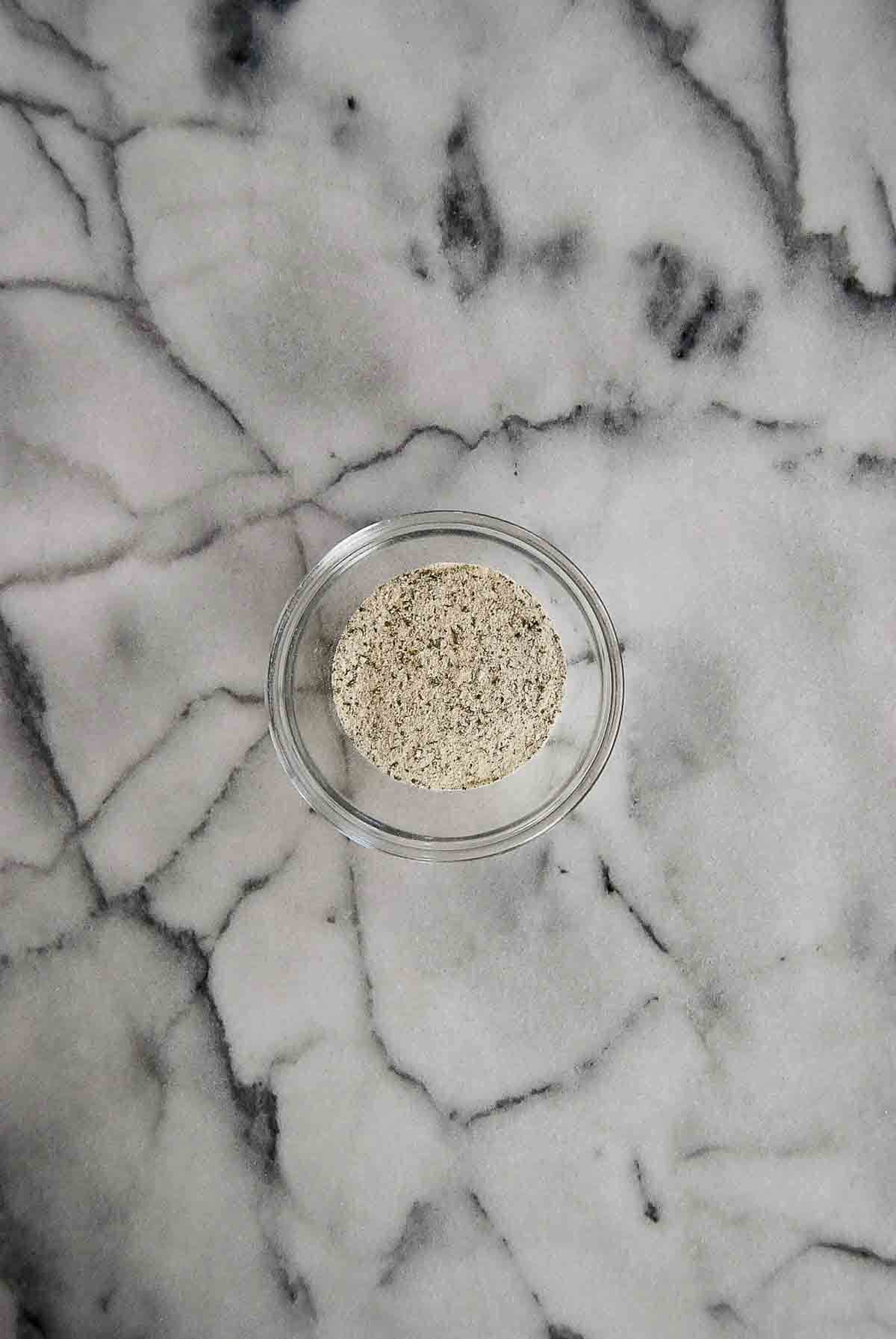 ranch seasoning in bowl on cutting board.