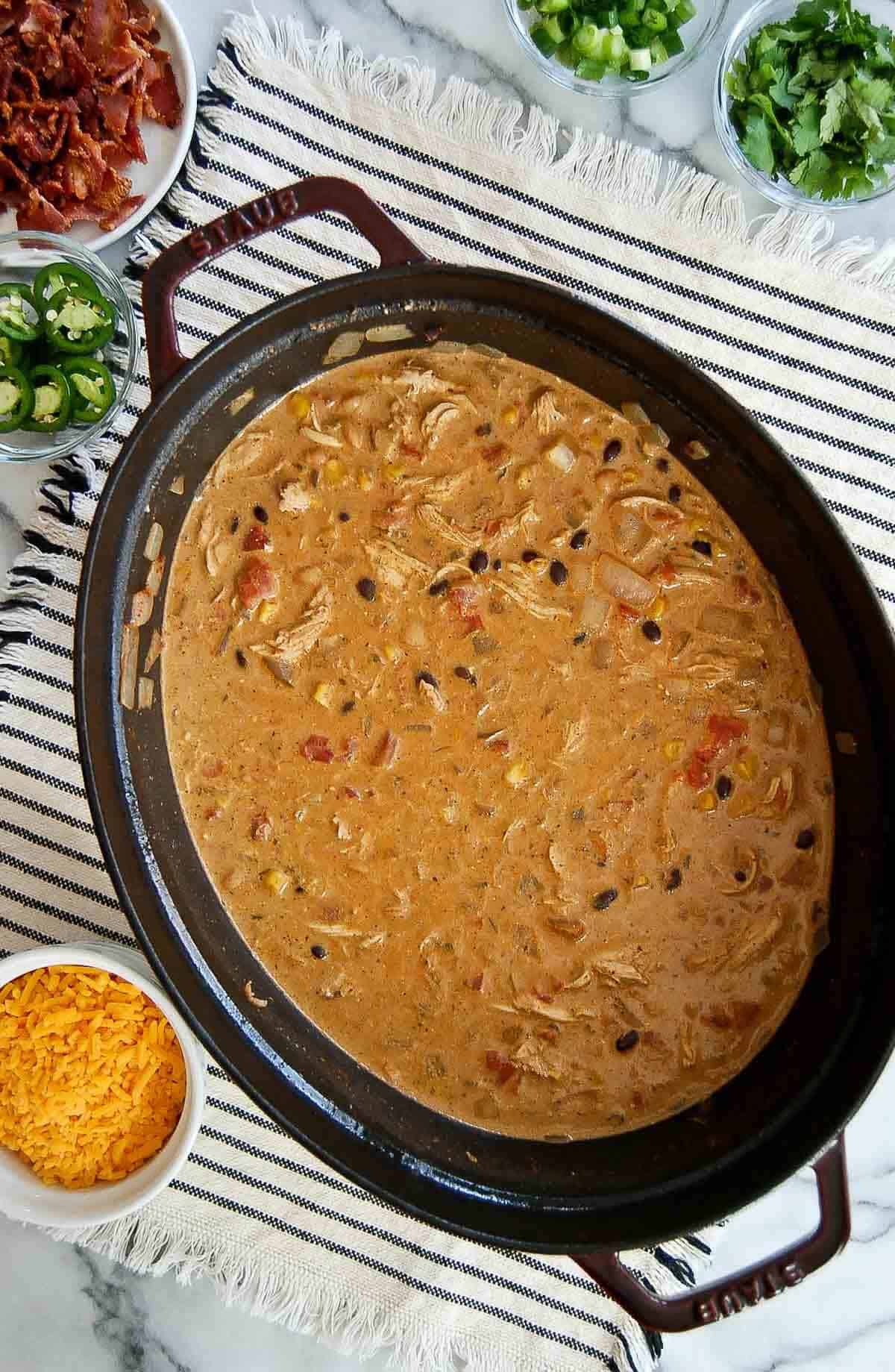 crack chicken chili in dutch oven on countertop.