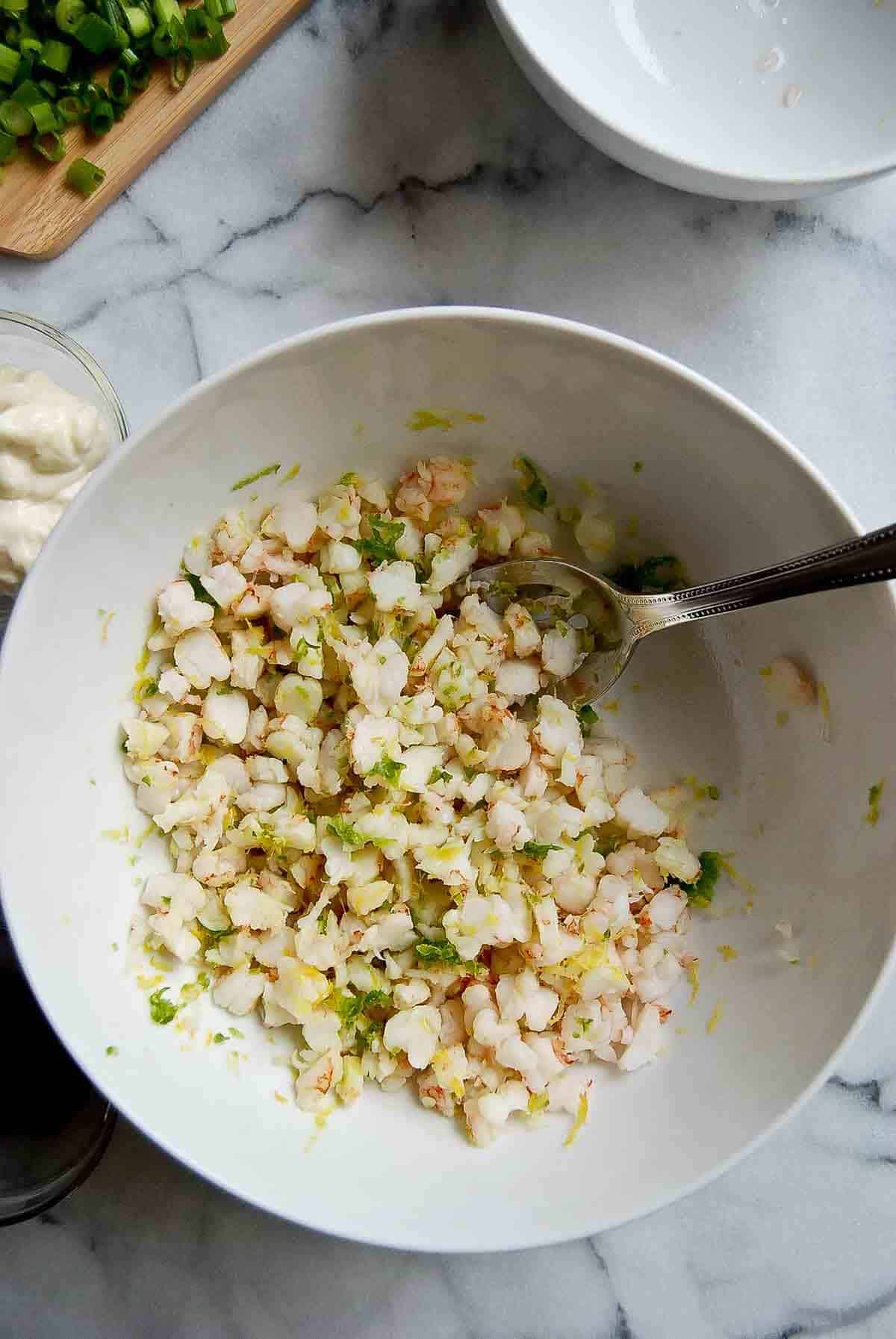 shrimp, lemon zest and grated jalapeno mixed in bowl.