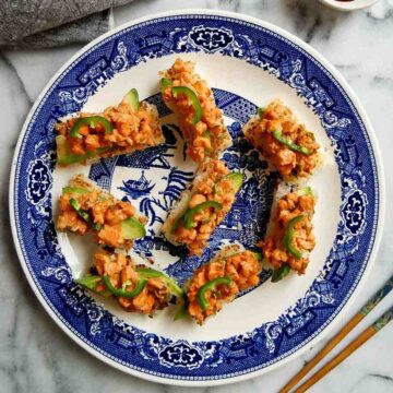 crispy rice with spicy shrimp salad with chopsticks and soy sauce on the side.