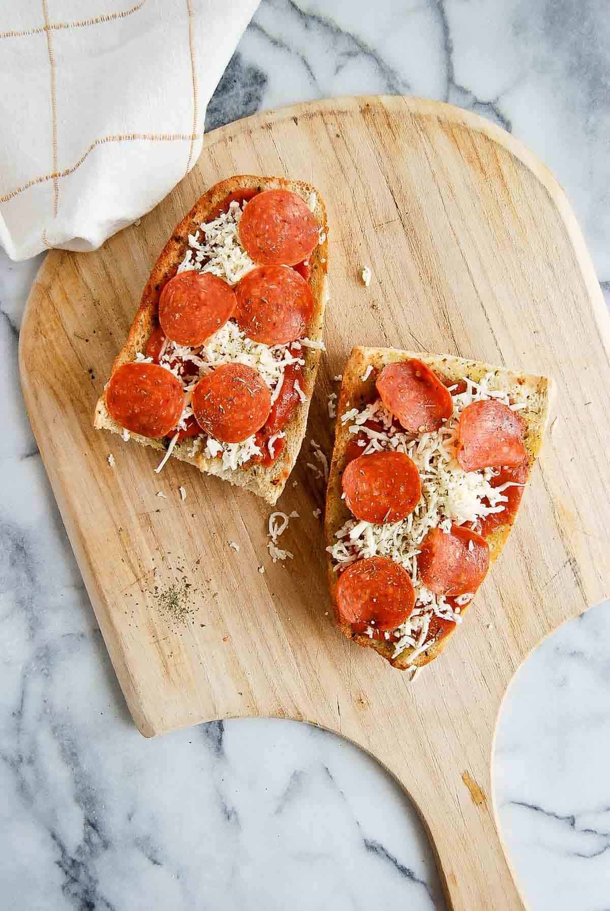 toasted french bread with pizza sauce, shredded mozzarella, and pepperoni on the top.