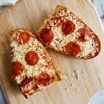 french bread pizza made in the air fryer, on a cutting board.
