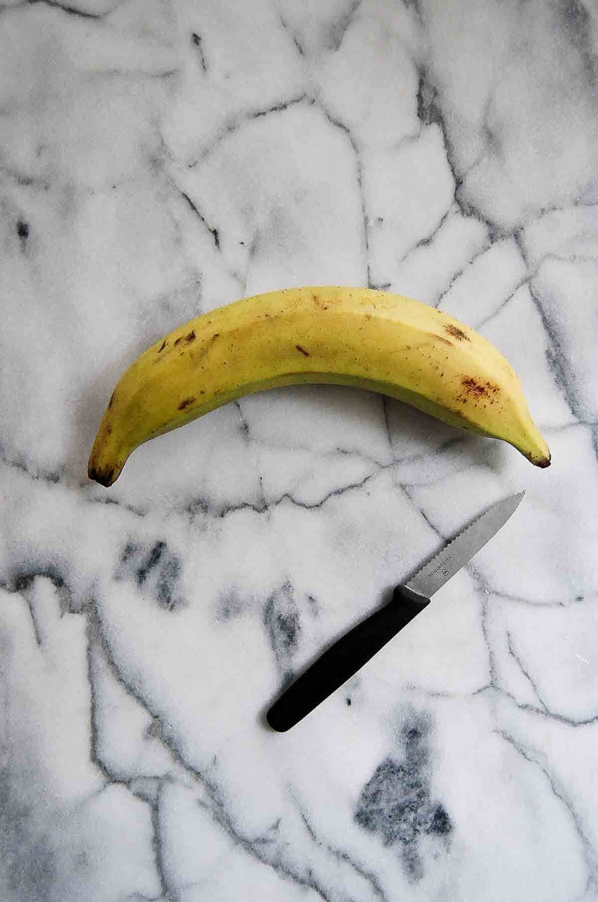 green plantain on cutting board.