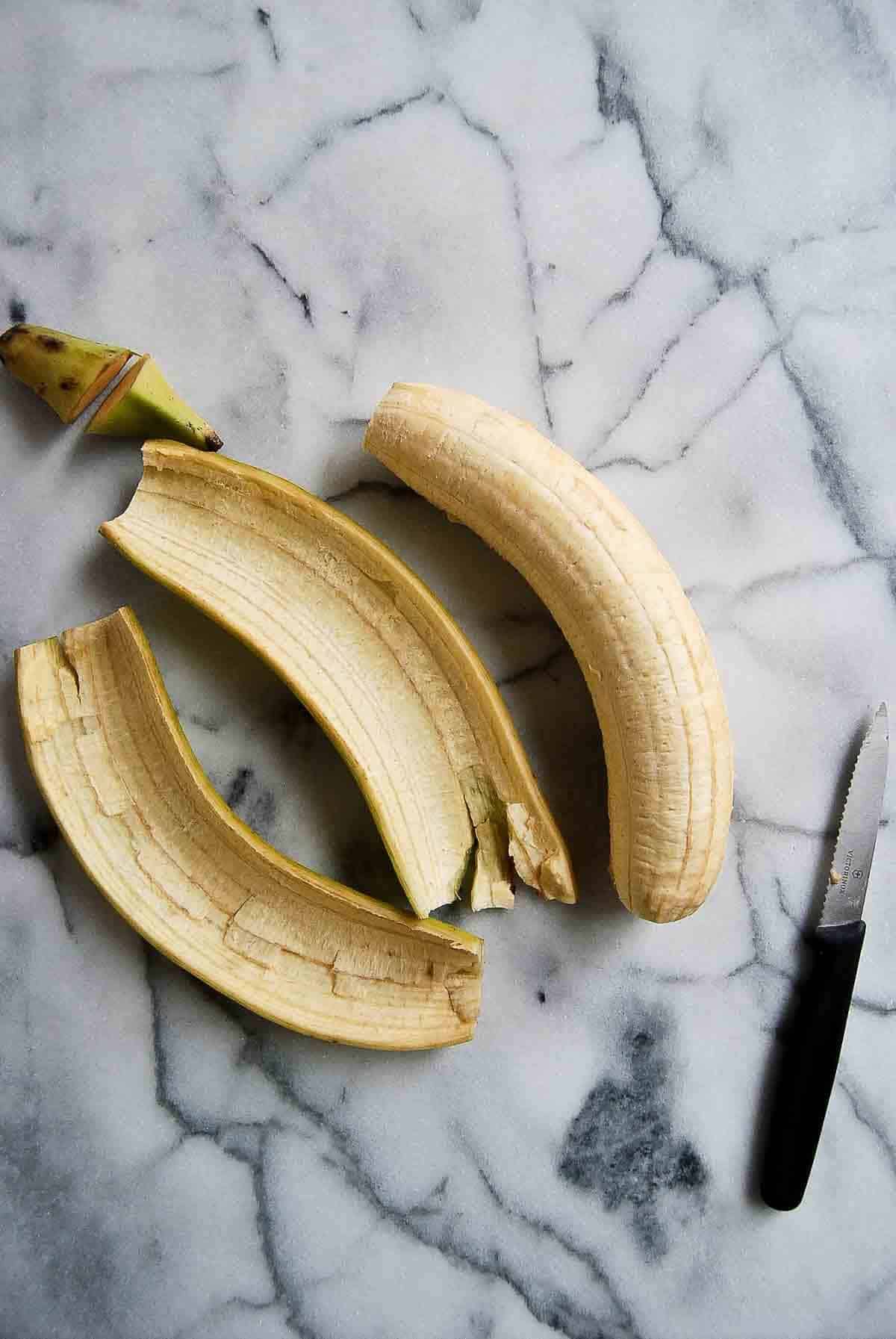 green plantain with whole peel removed.