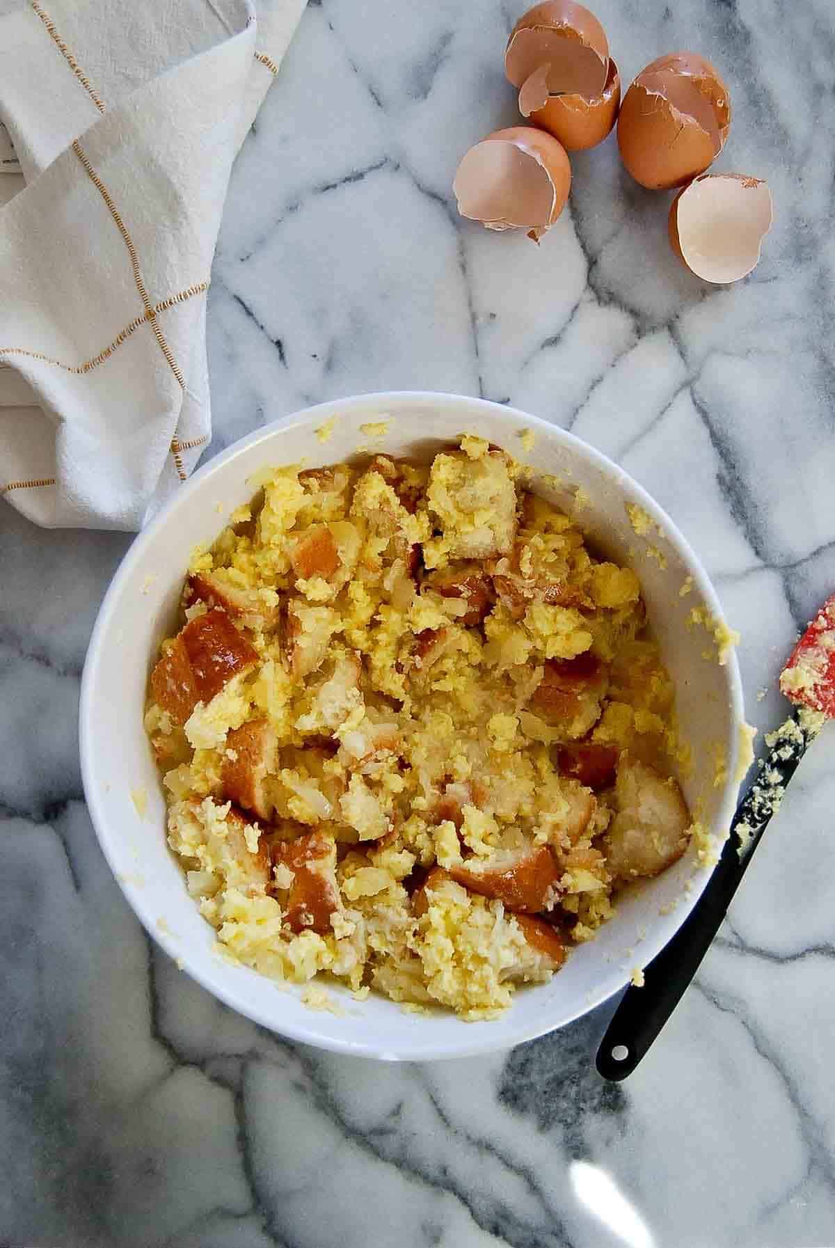 bowl of bread cubes mixed with pineapple and butter mixture.