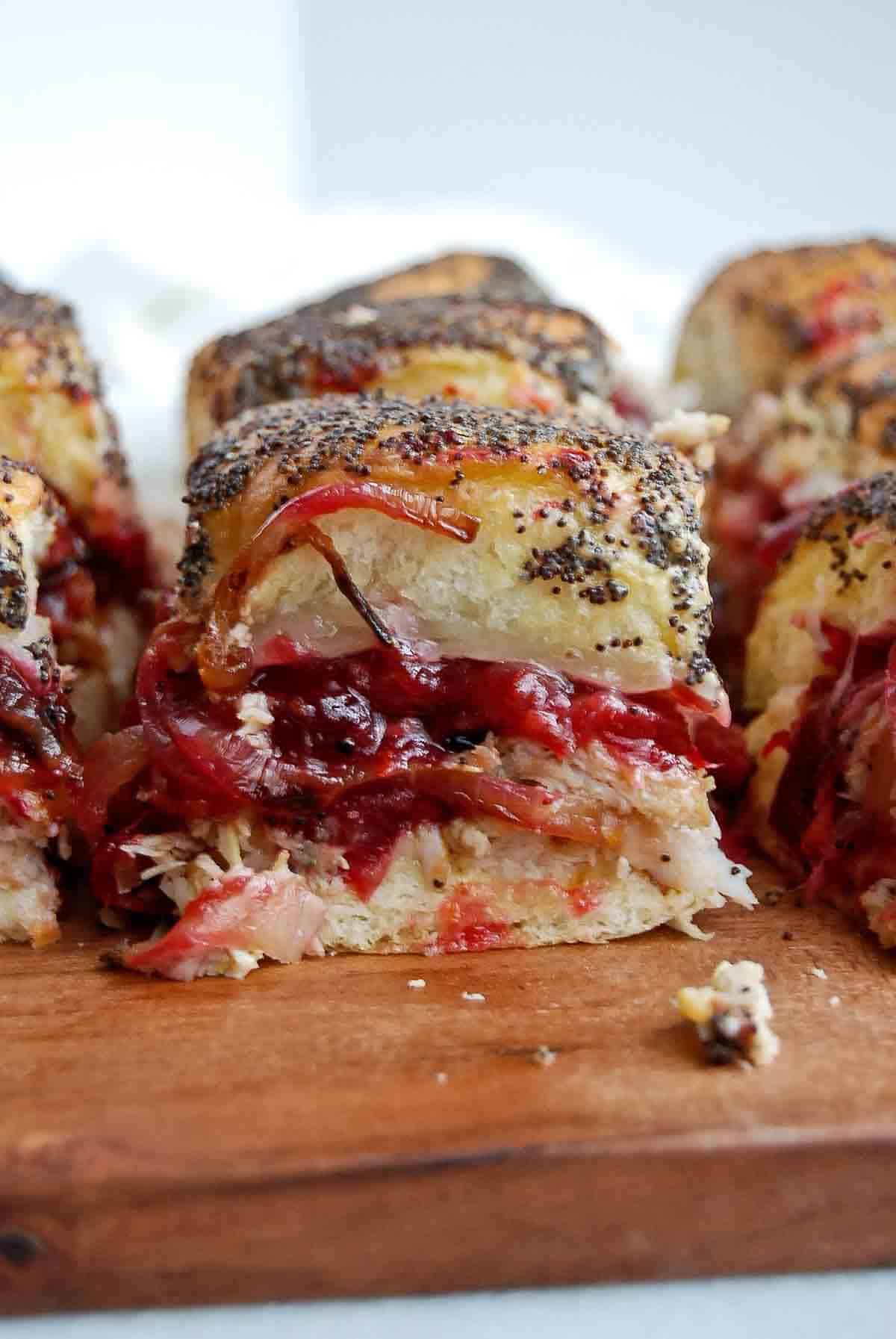 closeup view of turkey cranberry slider on cutting board.