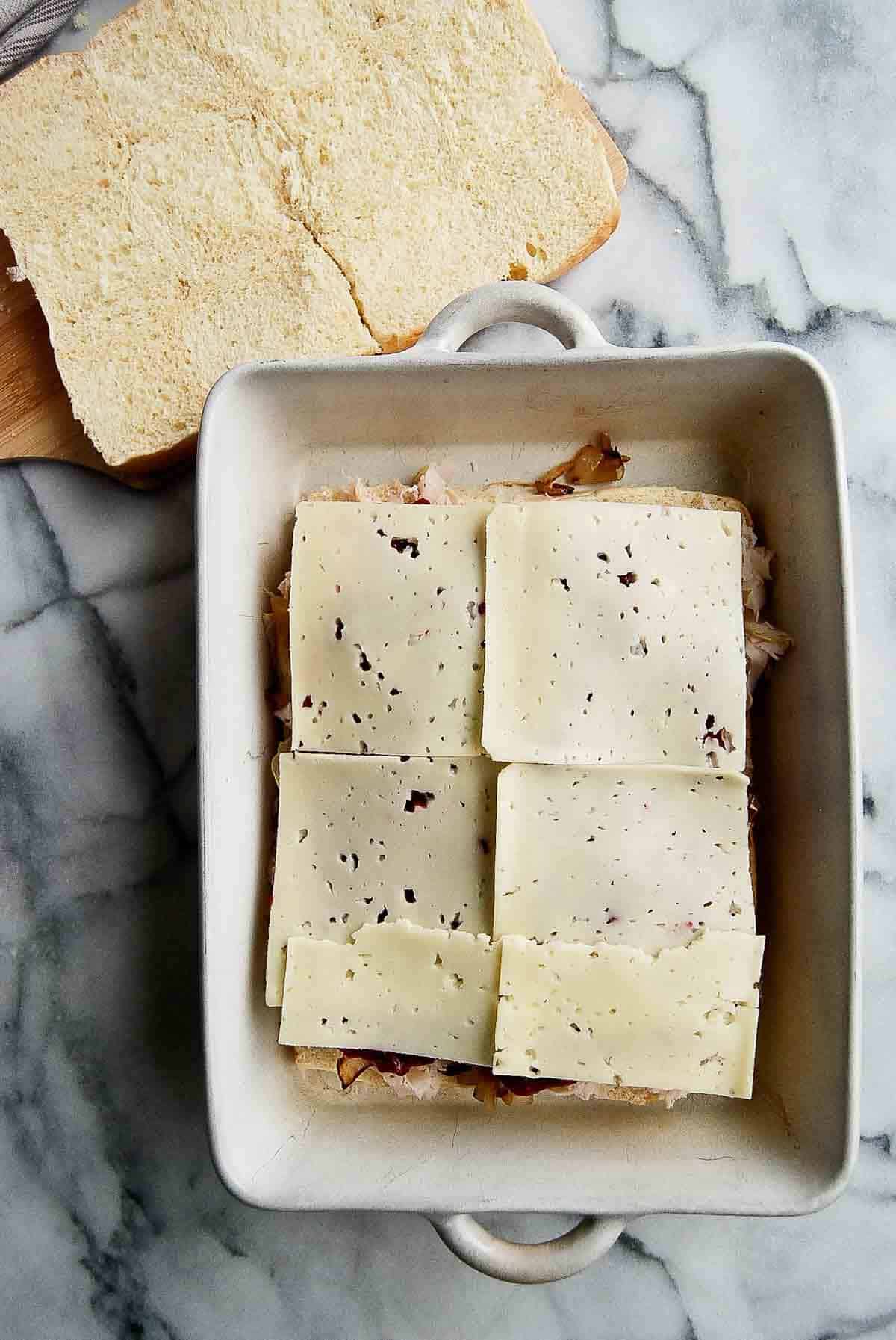 rolls with turkey, caramelized onions, cranberry sauce and slices of havartii cheese added to the top.