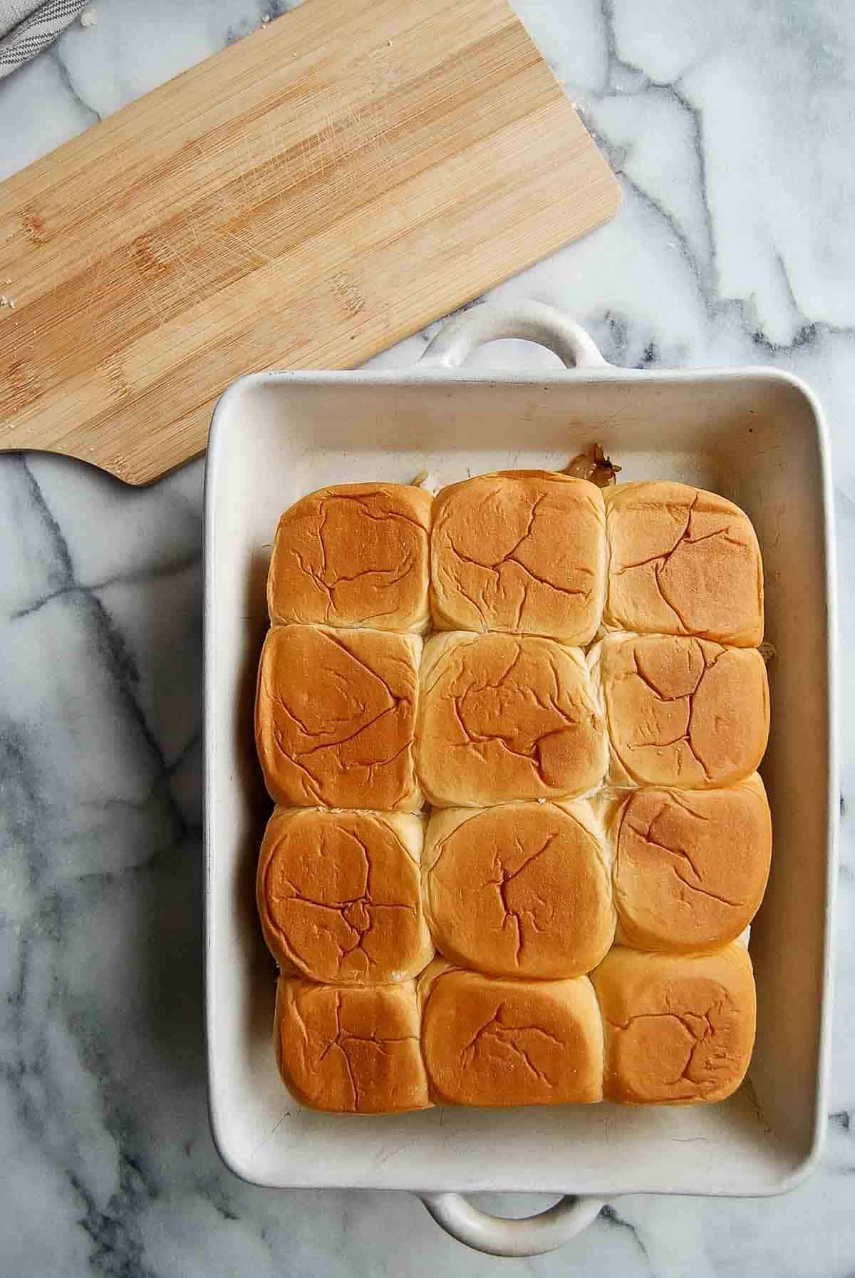 fully assembled turkey cranberry sliders in baking dish.