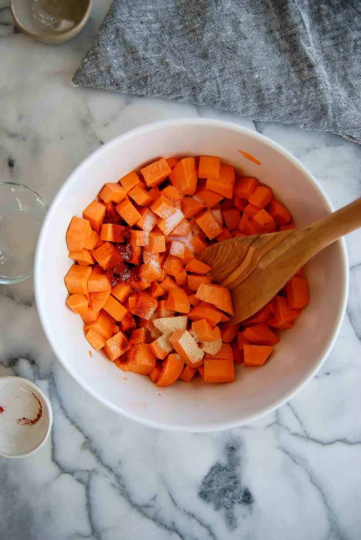 sweet potato cubes tossed with oil and cubes.