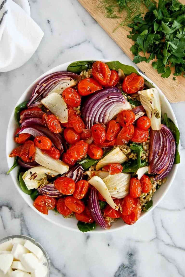 farro mixed with pesto, topped with blistered tomatoes, red onion, garlic and farro.