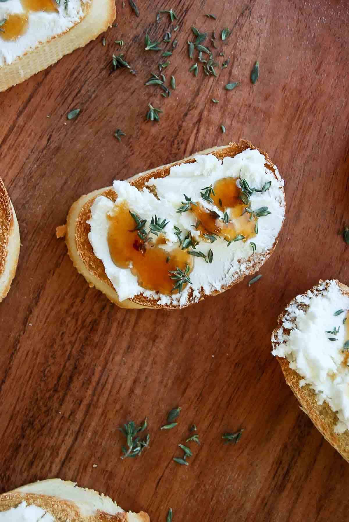 goat cheese crostini on cutting board.