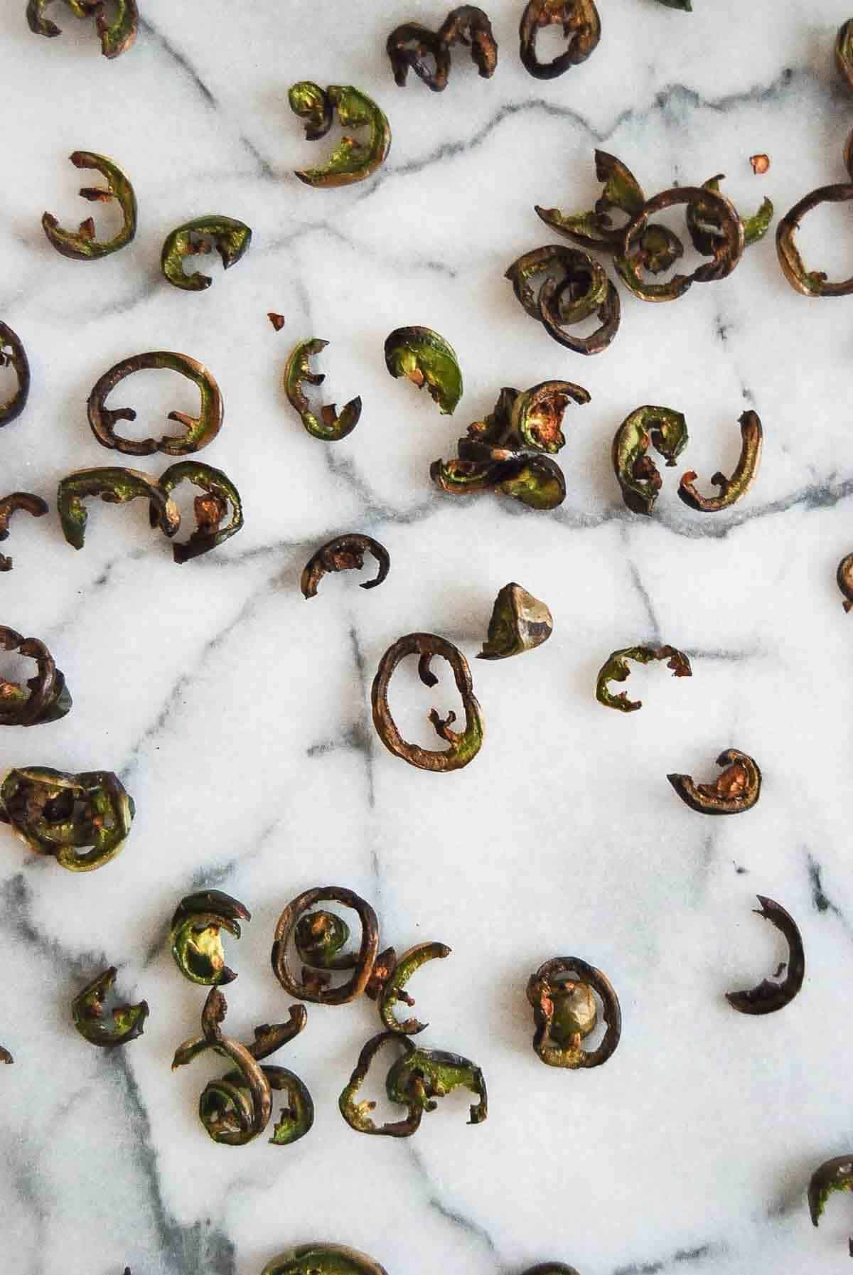 dehydrated jalapeno pepper slices on countertop.