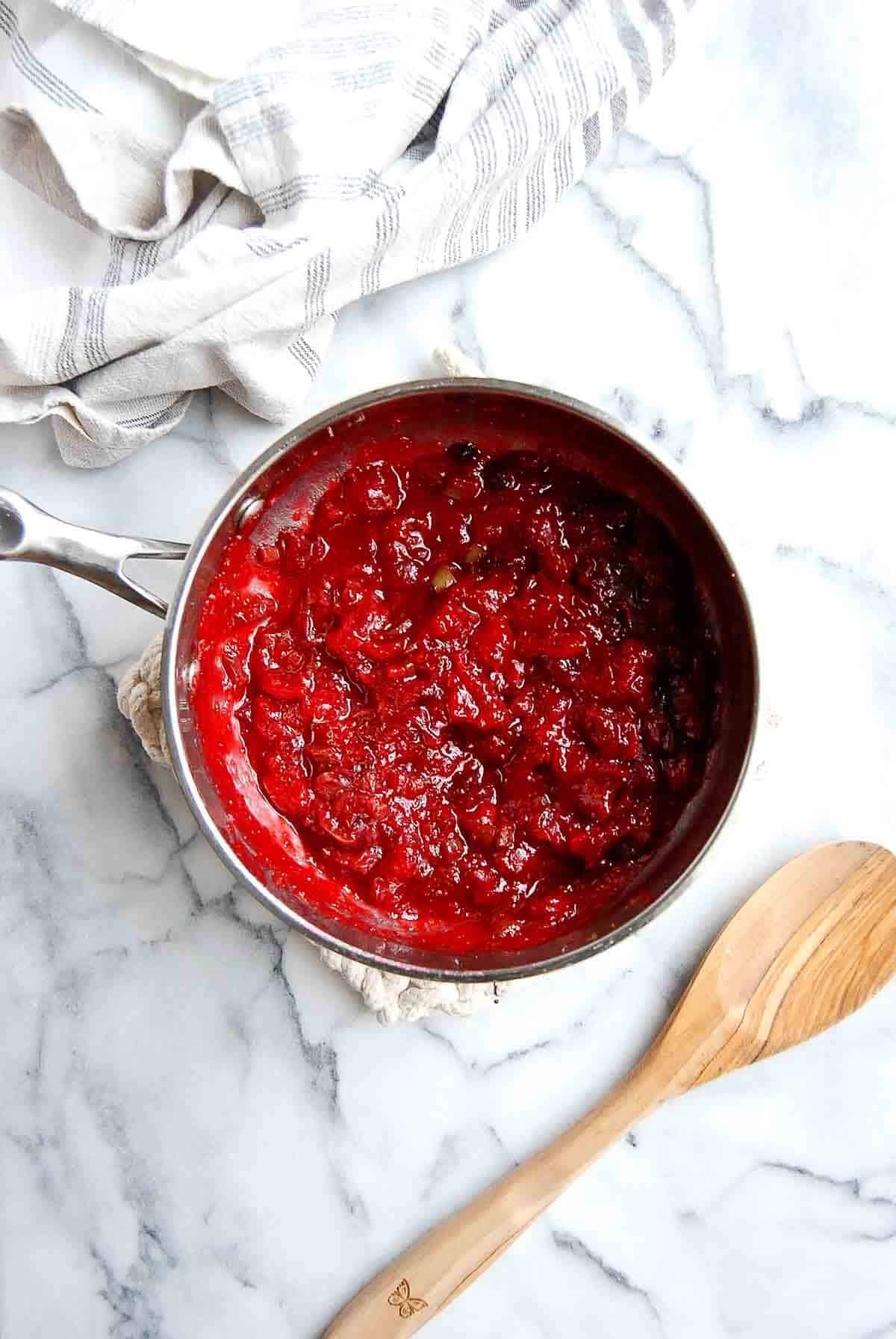 Cooked jalapeno cranberry sauce in sauce pan.