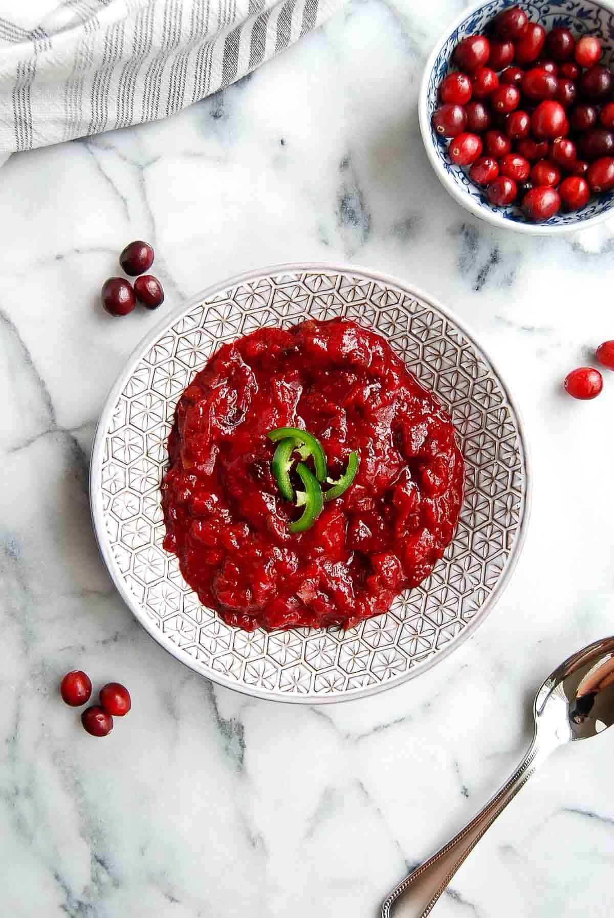 jalapeno cranberry sauce in serving bowl on countertop.