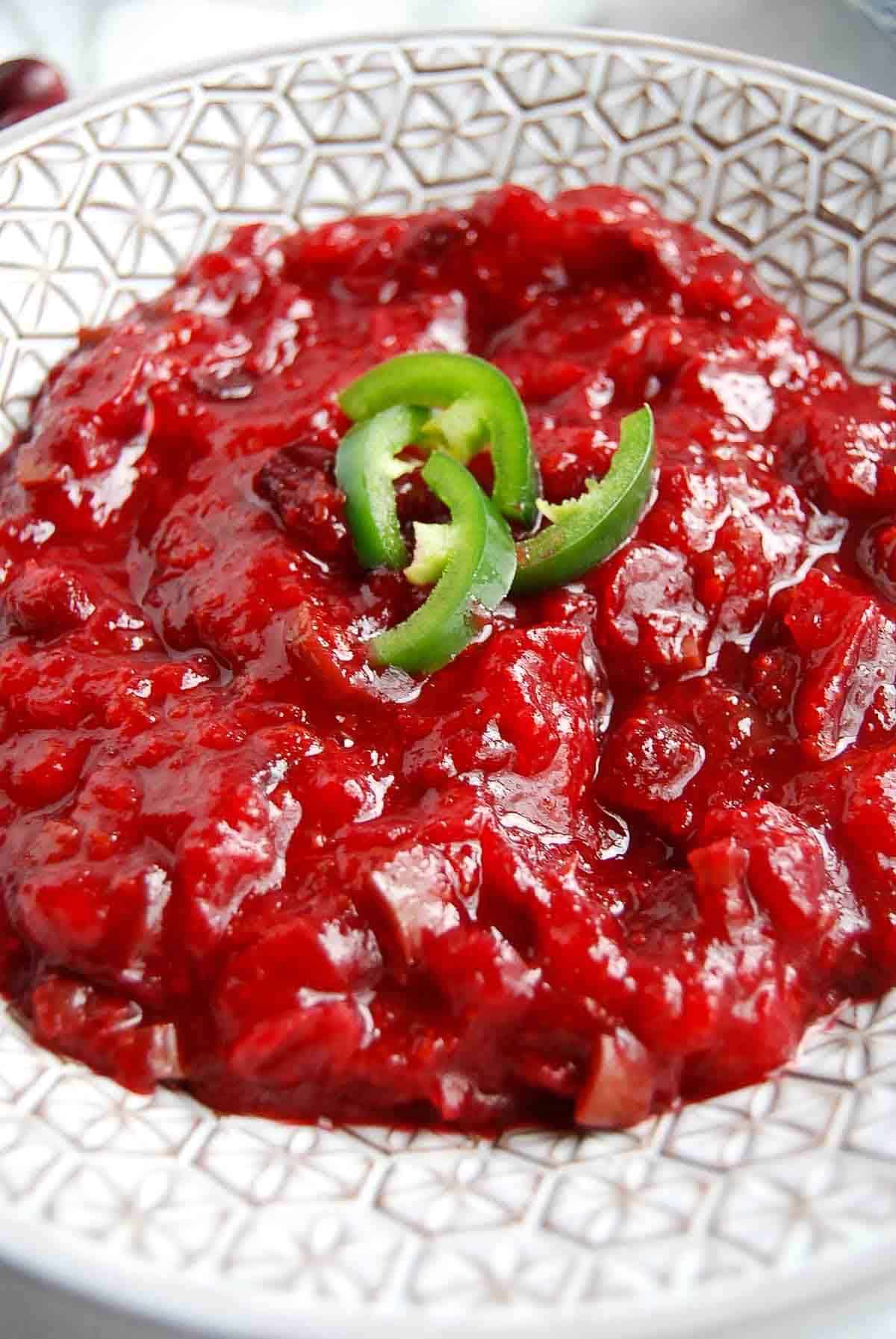 side view of jalapeno cranberry sauce in serving bowl.