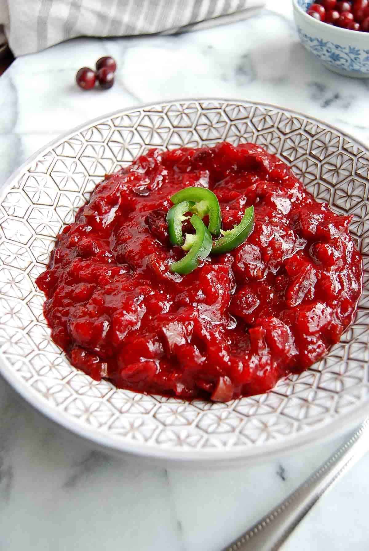 side view of jalapeno cranberry sauce in serving bowl.