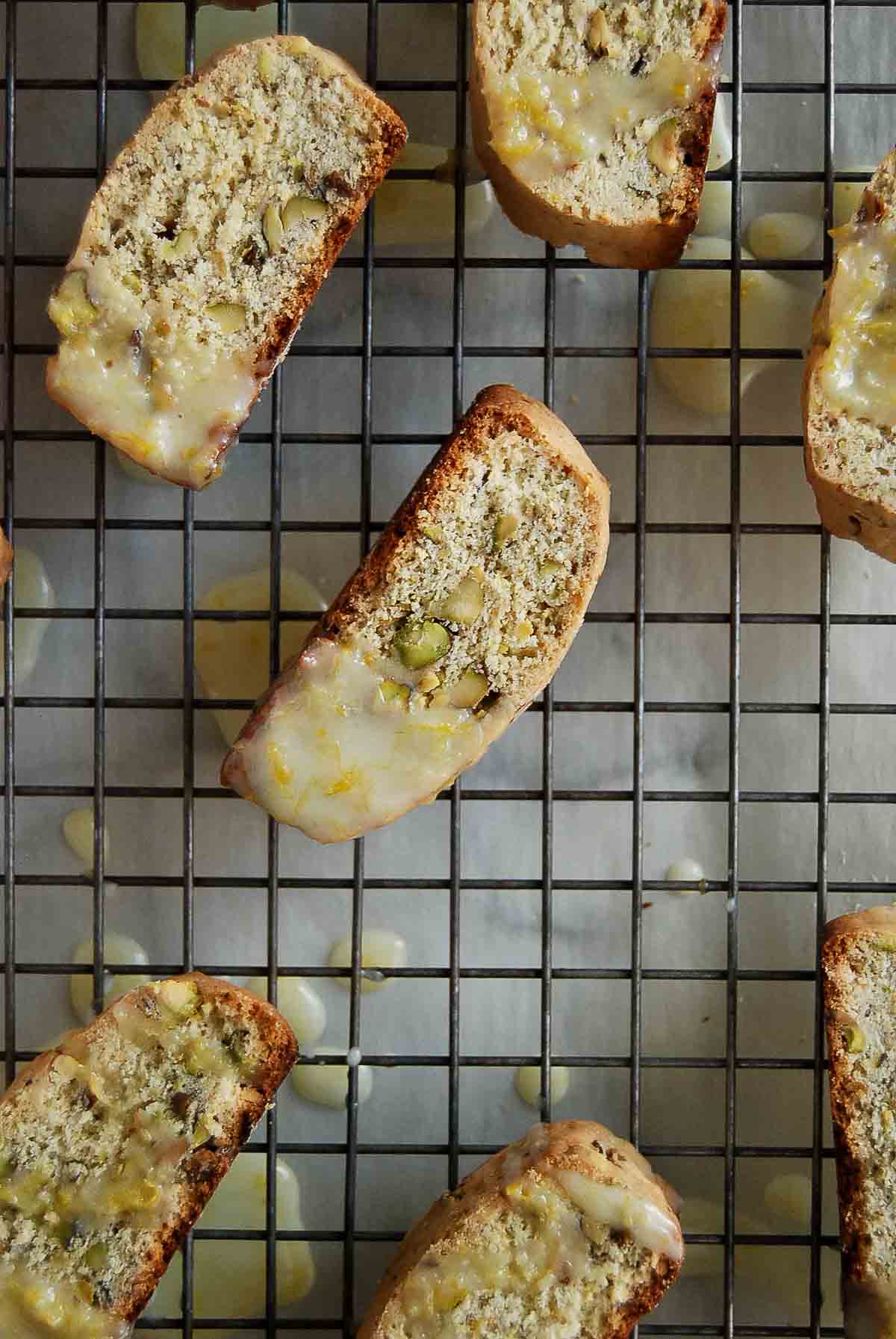 lemon glazed biscotti cookies on cooling rack.