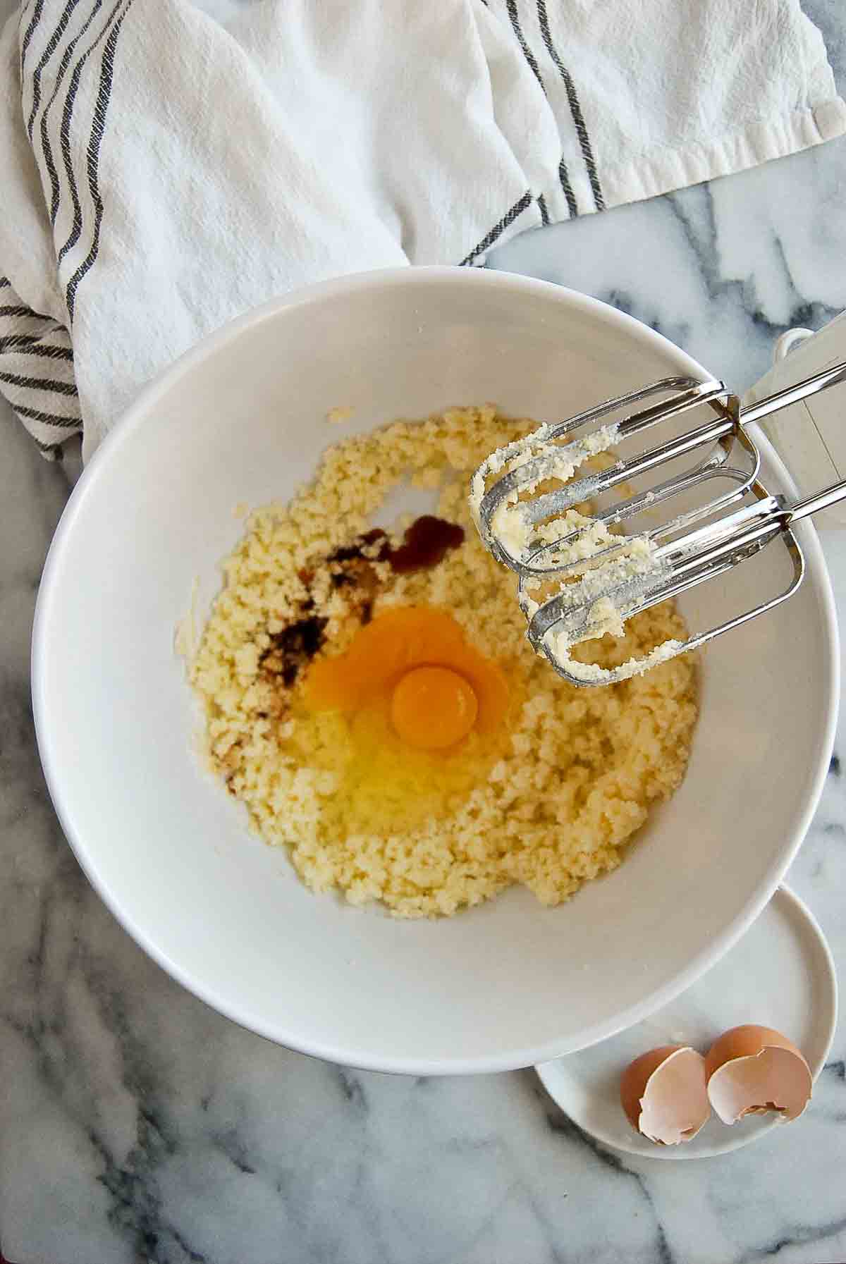 creamed sugar and butter in bowl with egg and vanilla extract.