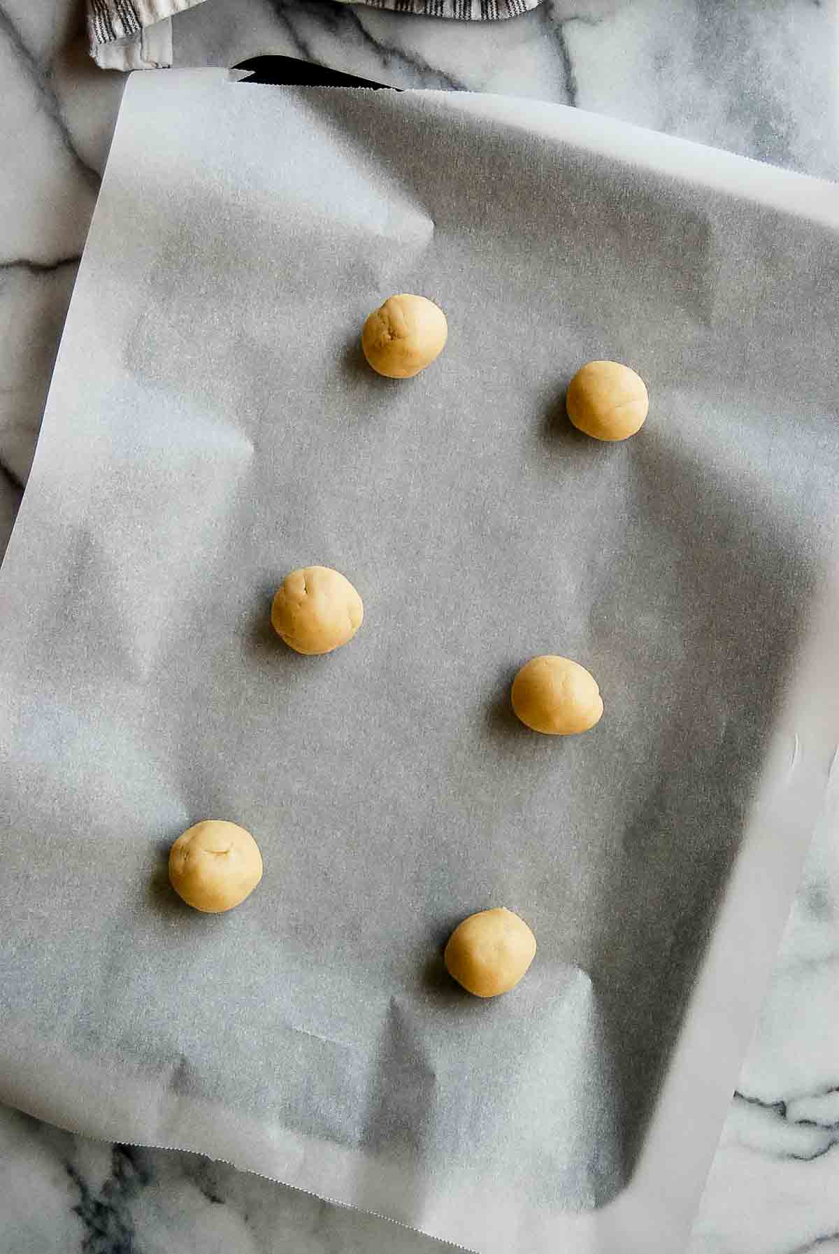cookie dough balls on large baking sheet.