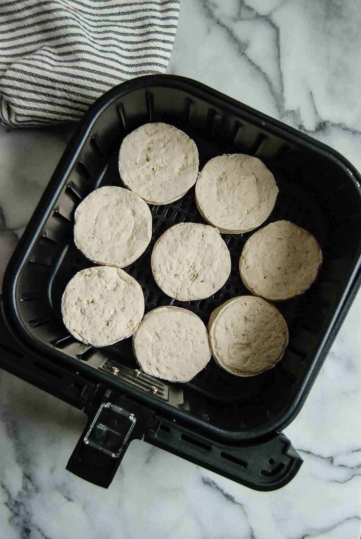 refrigerated biscuits in air fryer basket.