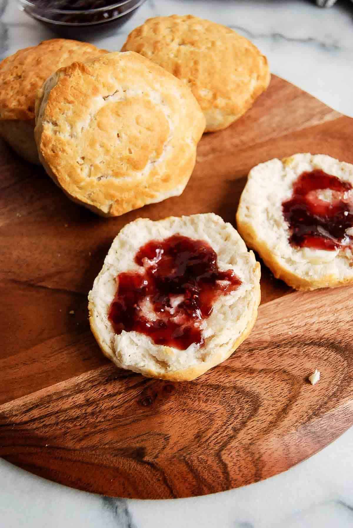 closeup of biscuit cut open with jelly spread on it.