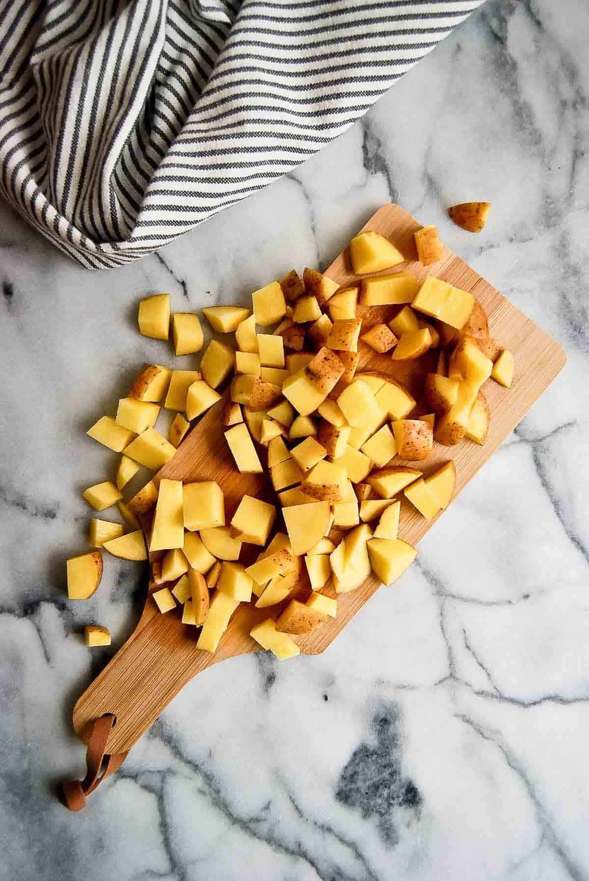 diced potatoes on cutting board.