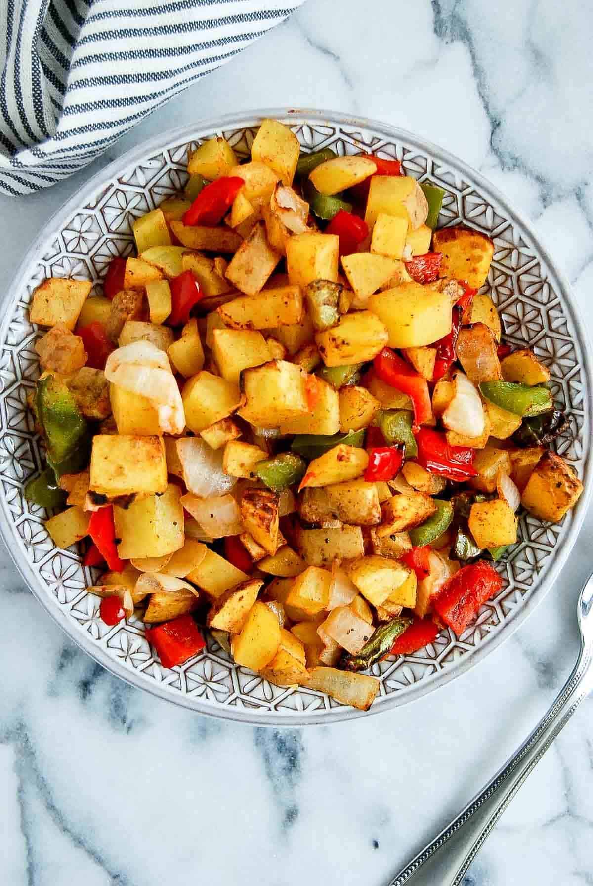 closeup of air fryer breakfast potatoes in serving bowl on countertop.