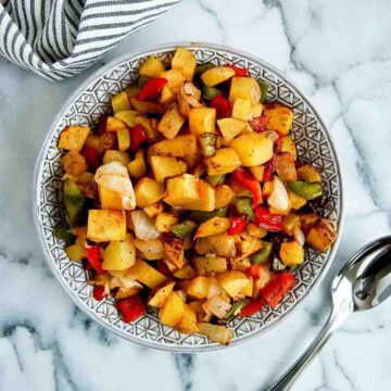 air fryer breakfast potatoes in bowl on countertop.