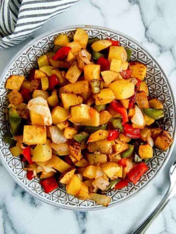 air fryer breakfast potatoes in bowl on countertop.